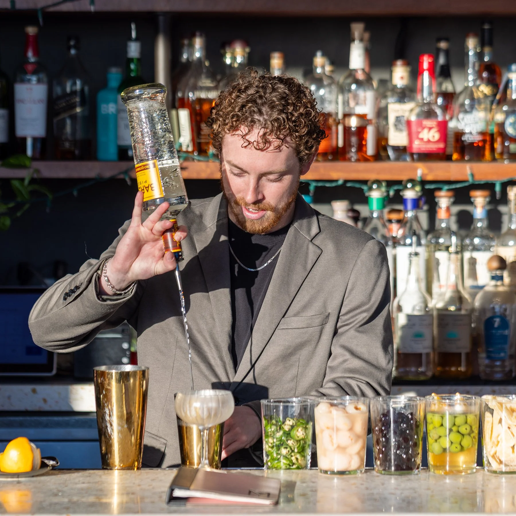 Bar manager Cole Biondi mixes a Pisco Sour.jpg