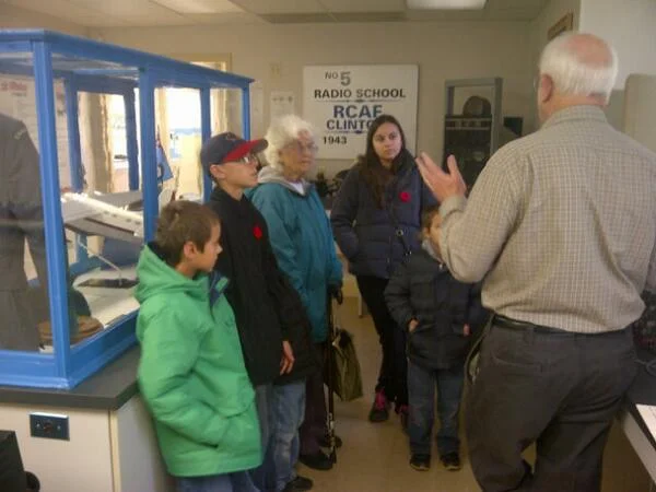 Hilda is surrounded by her family, attentively listening to one of our volunteers talking about wavelengths.