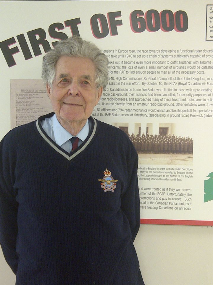 RoyTaylor (2013) stands in front of his 1940 enlistment group photo.