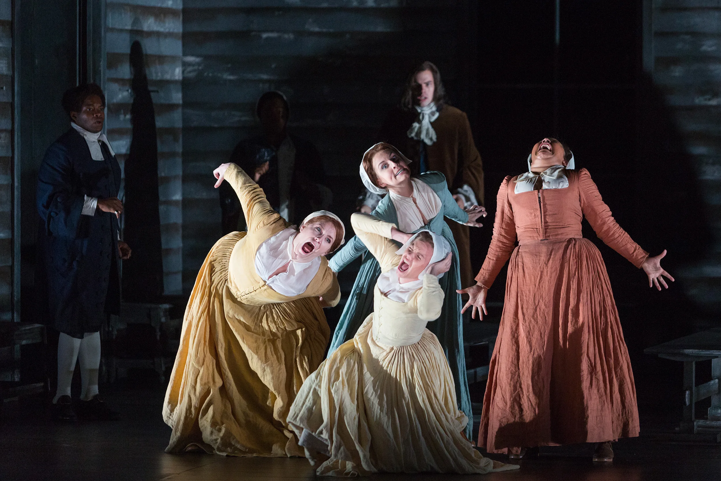 Clockwise from top: Mary Beth Nelson as Betty Parris, Ariana Wehr as Abigail Williams, Emma Grimsley as Ruth Putnam and Molly Jane Hill as Susanna Walcott in The Glimmerglass Festival's production of Robert Ward's The Crucible .