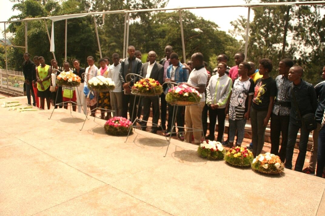 Youth place flowers during a visit to Kigali Genocide Memorial Center 