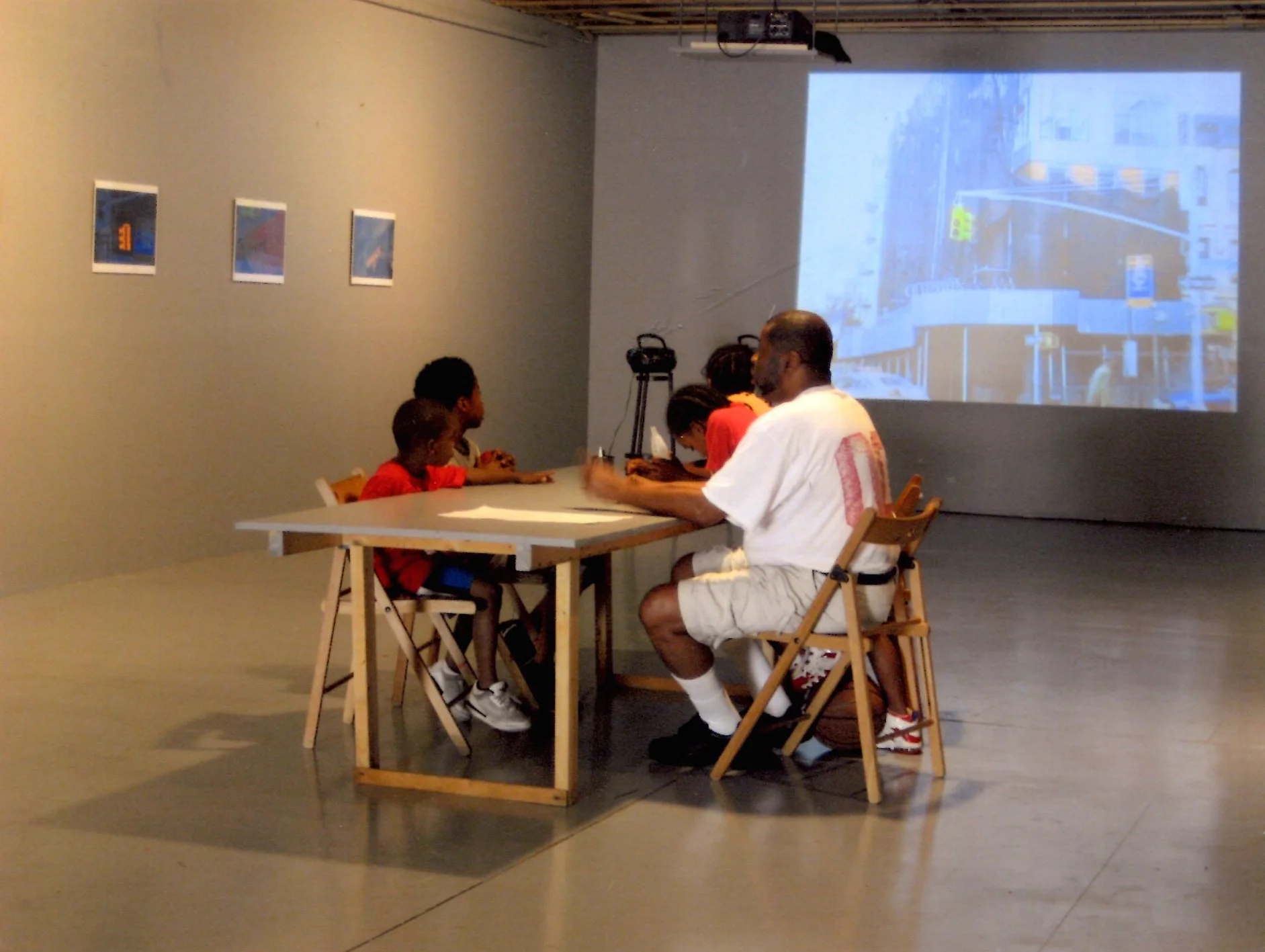 Exhibition view of There Goes the Neighborhood , a sound installation of “voices from the other side of Brooklyn’s real estate boom”, shown alongside photographs of Crown Heights by Michael Britto. 2007