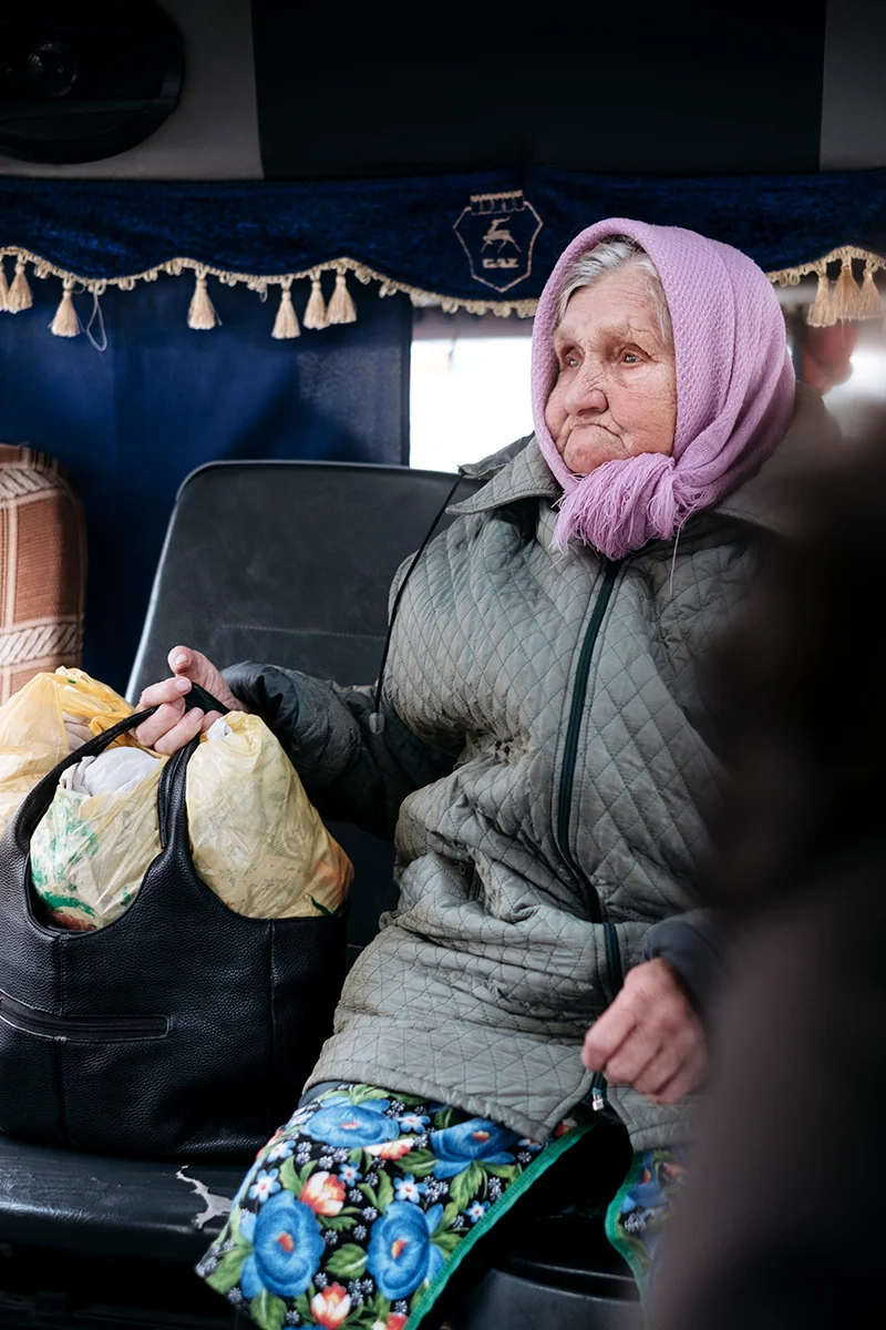 An old woman in a Marshrutka (маршру́тка) a minibus for public transportation in Tatarsk.