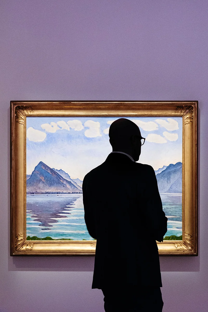 A visitor observing Ferdinand Hodler painting “Lake Thun, symmetric reflection” on display at the Rath museum in Geneva during the Hodler Parallelism temporary exhibition.