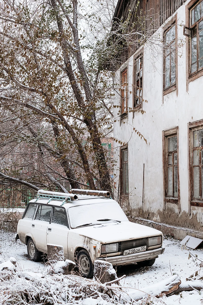 An old Lada car in the snow.