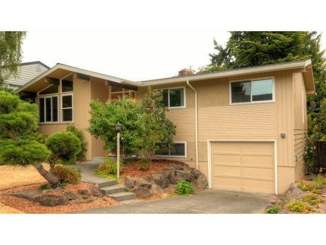 Pride of ownership is evident throughout this warm & inviting Mid-Century split-level. Up features 3 Beds with full bath and a master bed with 3/4 ensuite bath. Entertain guests in the elegant living/dining room with vaulted ceilings, exposed beams and balcony. Functional kitchen that is your blank slate in the future. Down is a huge family room with a walk out to the big fully fenced back yard a 3/4 bath, laundry, attached one car garage and a 4th bed or office bonus!