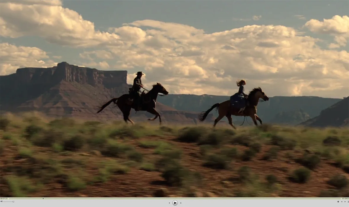 Marsden & Wood (or stunt doubles) riding through Castle Valley