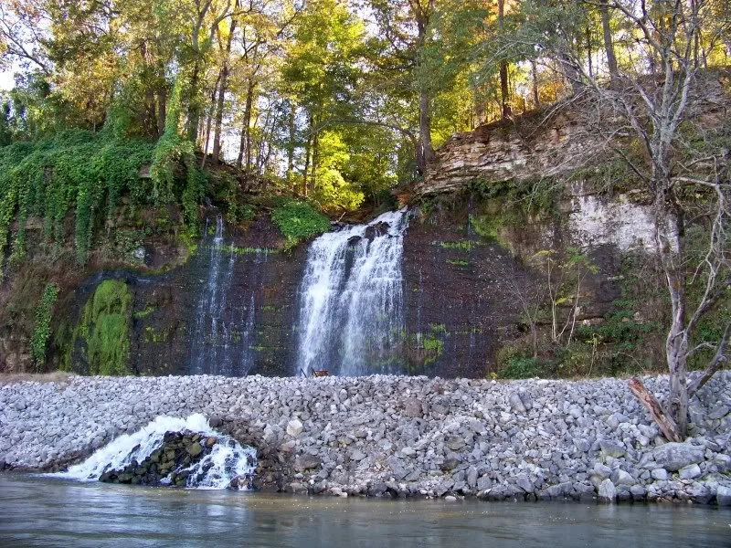 A waterfall above the rip rap.