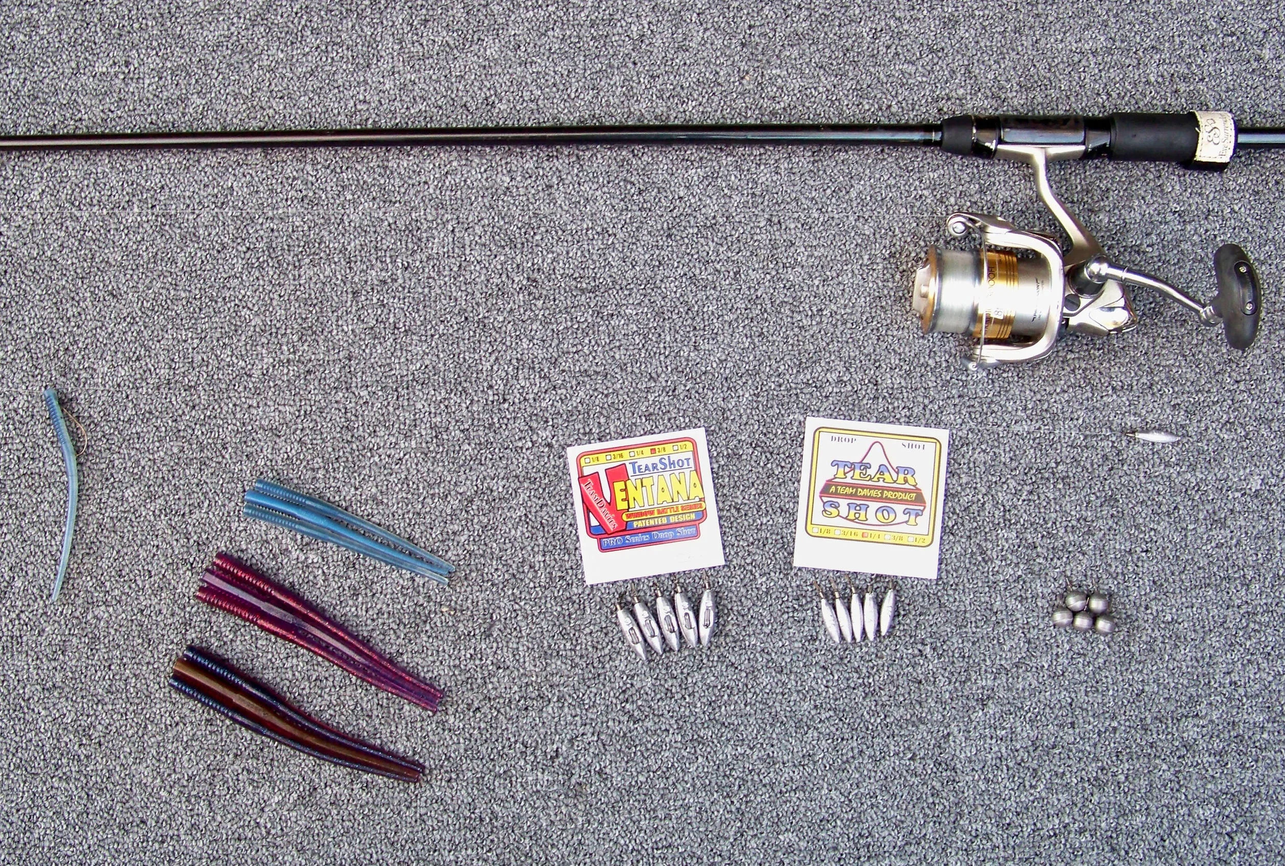 With clouds and strong wind present, the fish favored Trigger X 5.5" Probe Worm Cheap Shot color (middle position) & Dirty Grape color (bottom position). When sunshine, blue skies and a calm breeze appeared, the 4" Probe Worm Pro Blue color (top position) scored. The 3/8 oz. Ventana rattling drop shot weight (left position), 1/4 oz. Tear Shot Slim Shot (center position), the 3/8 oz. Tear Shot Bulk Shot tungsten weight (right position). The length of the drop is shown from the individual Slim Shot weight below the reel and the single Pro Blue worm far left, The 8 lb. fluorocarbon line is not visible in the photo.