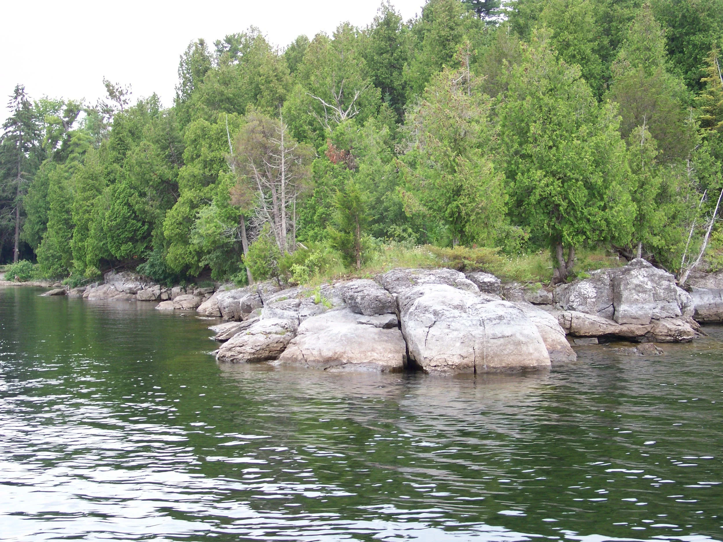 This rocky point on Valcour Island just south of Plattsburgh New York has a shallow bay to the left and steep bluff walls to the right.