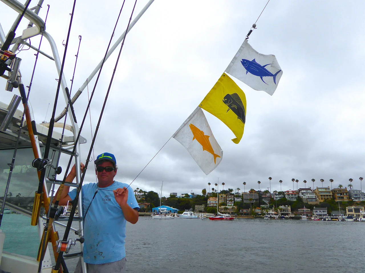 Bongo II with deck hand Marty and Capt Joe putting up the fish flags.