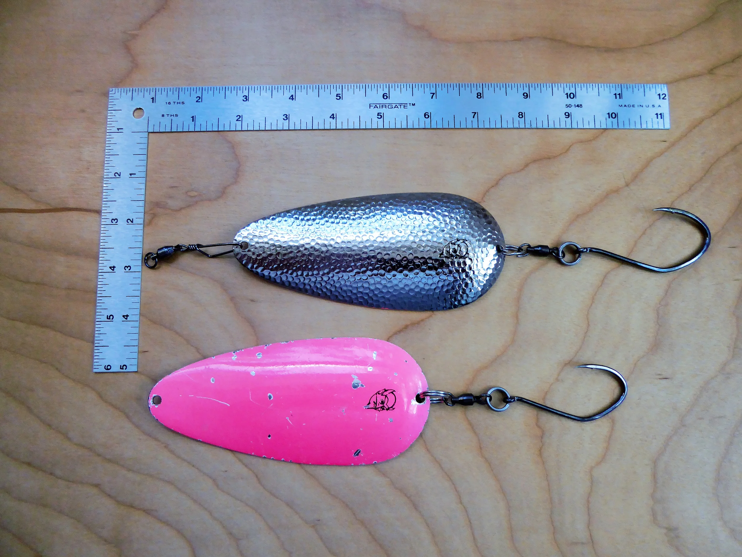 Husky Delve spoon by Eppinger. These spoons have upgraded spilt rings, SPRO barrel swivels, SPRO #5 coast lock snap swivels, and Gamakatsu Big River Bait hooks barbs crimped. These changes improve line twist and prevent a twisting hooked fish from binding the split ring and hook against the lure gaining leverage to pull the hook out. A lot of teeth marks on the pink!