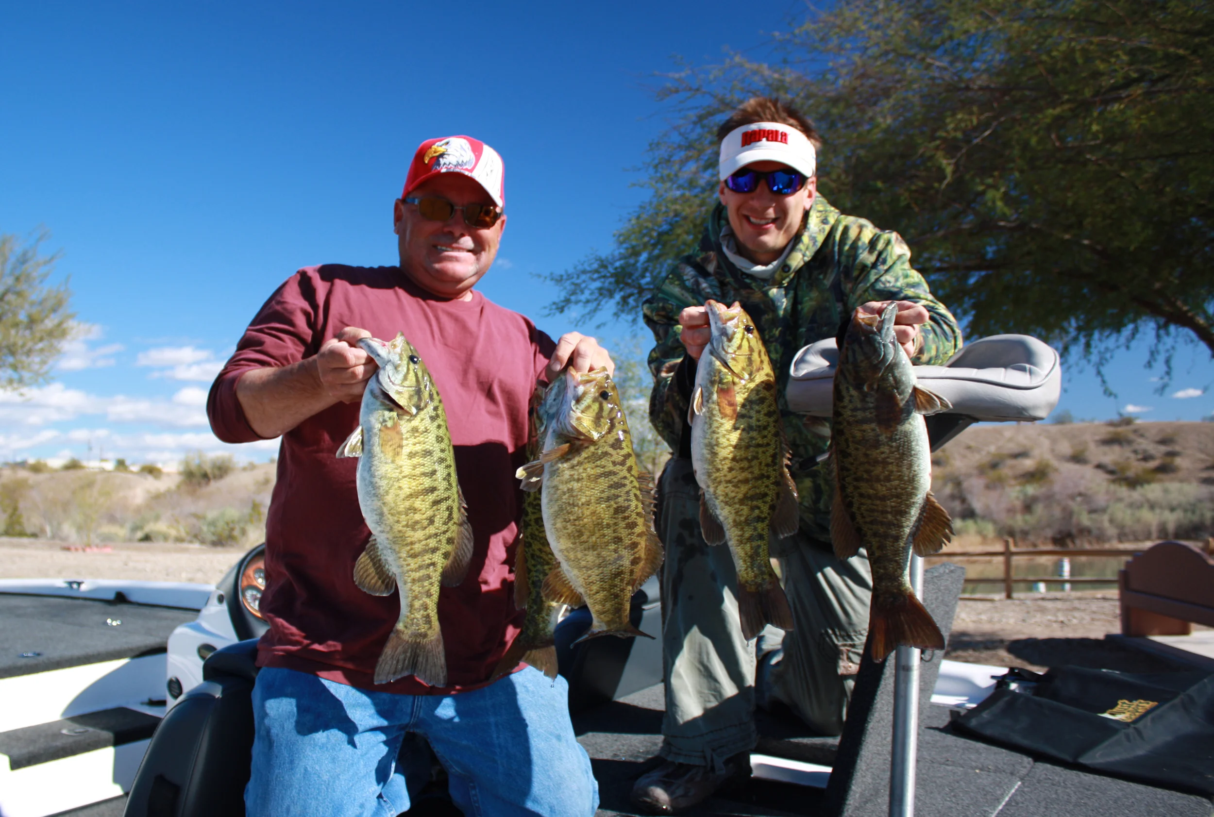 Troy Lindner assisting Walt Kondraki with his heavy limit of Havasu Smallies