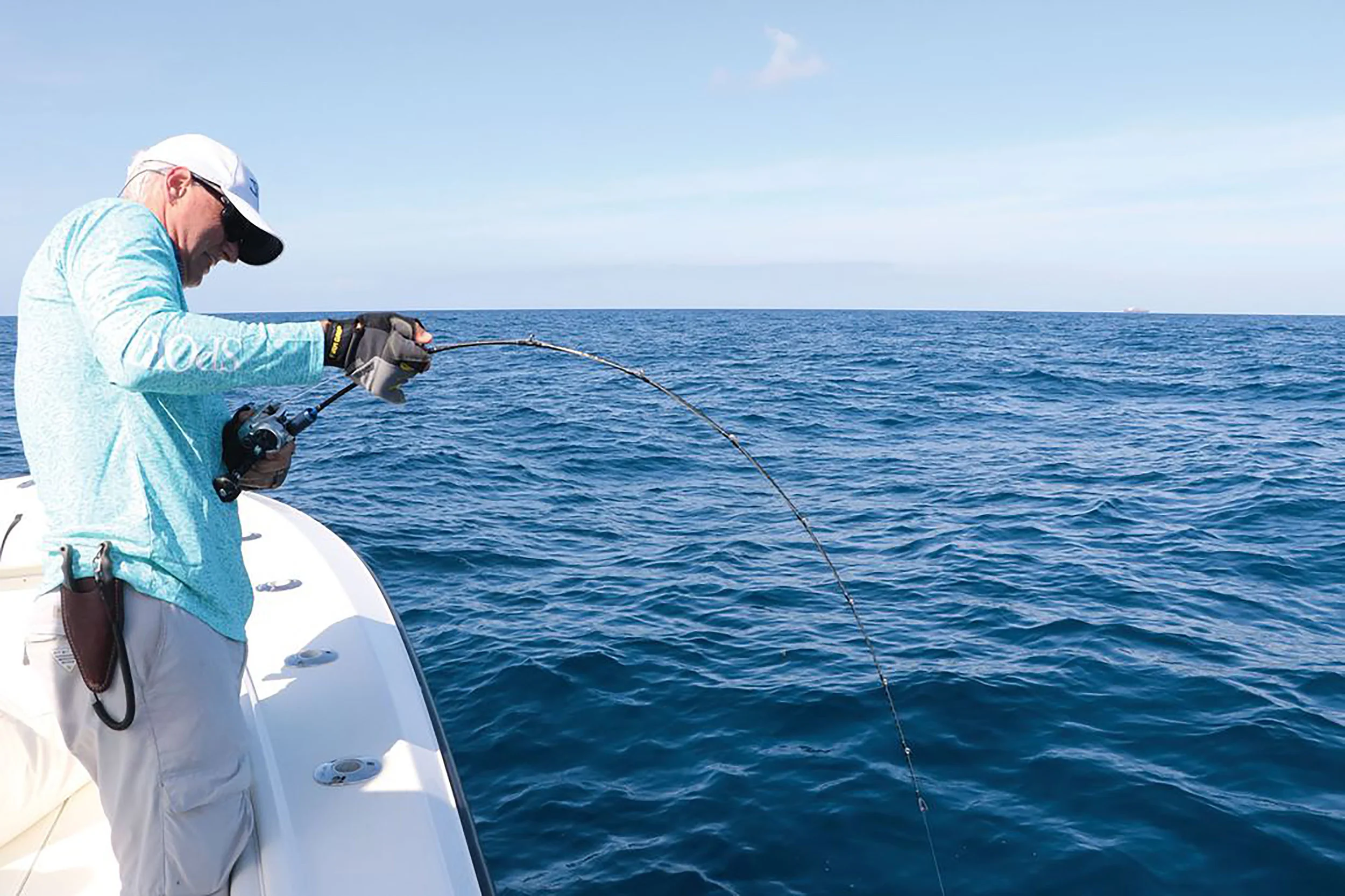 The current crop of slow-pitch jigging rods have a very slow, even taper and bend from the tip to the reel, but can sustain an amazing amount of pressure, as seen in this angler-versus-amberjack battle. Better, though, to keep the leading hand on the short foregrip rather than the rod itself, though it’s easy to do the latter. Doug Olander / Sport Fishing