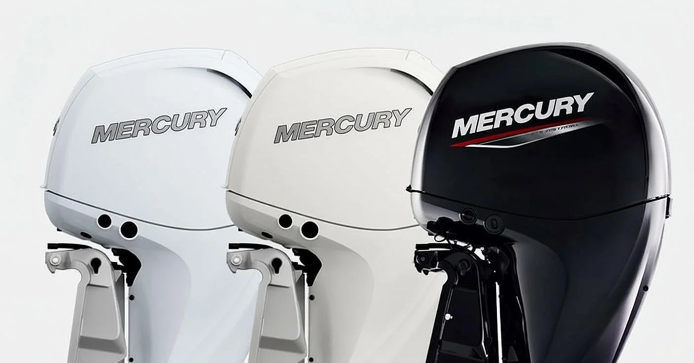 Three Mercury outboard motors in black, white, and gray colors lined up side by side.