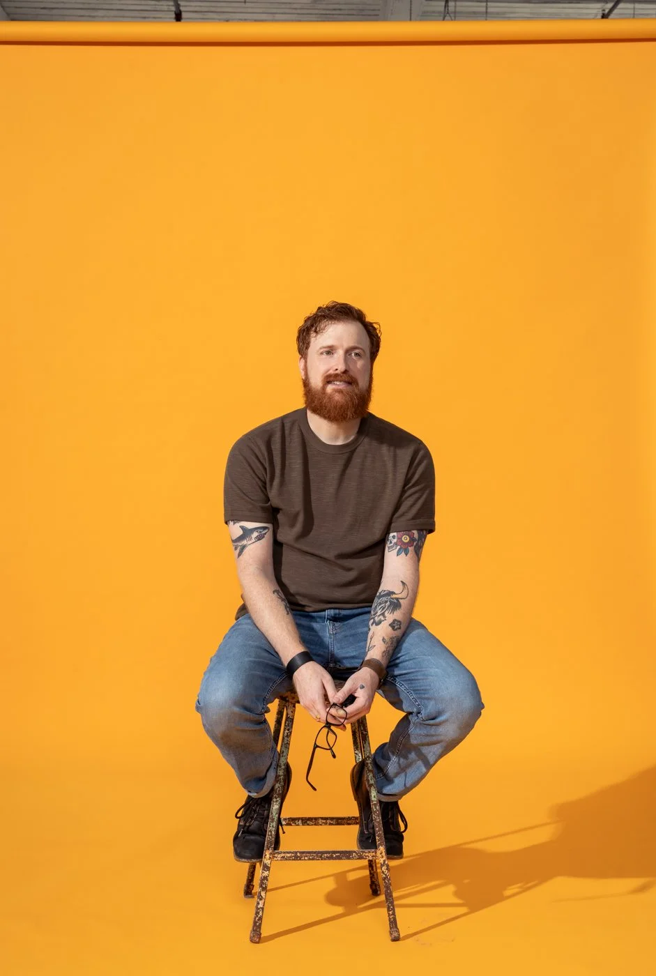 Portrait of Eli Warren in front of a yellow background