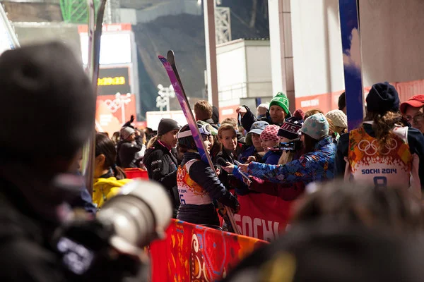 Lindsey Van talks with a group of women sports journalists from the U.S. after the historic event.