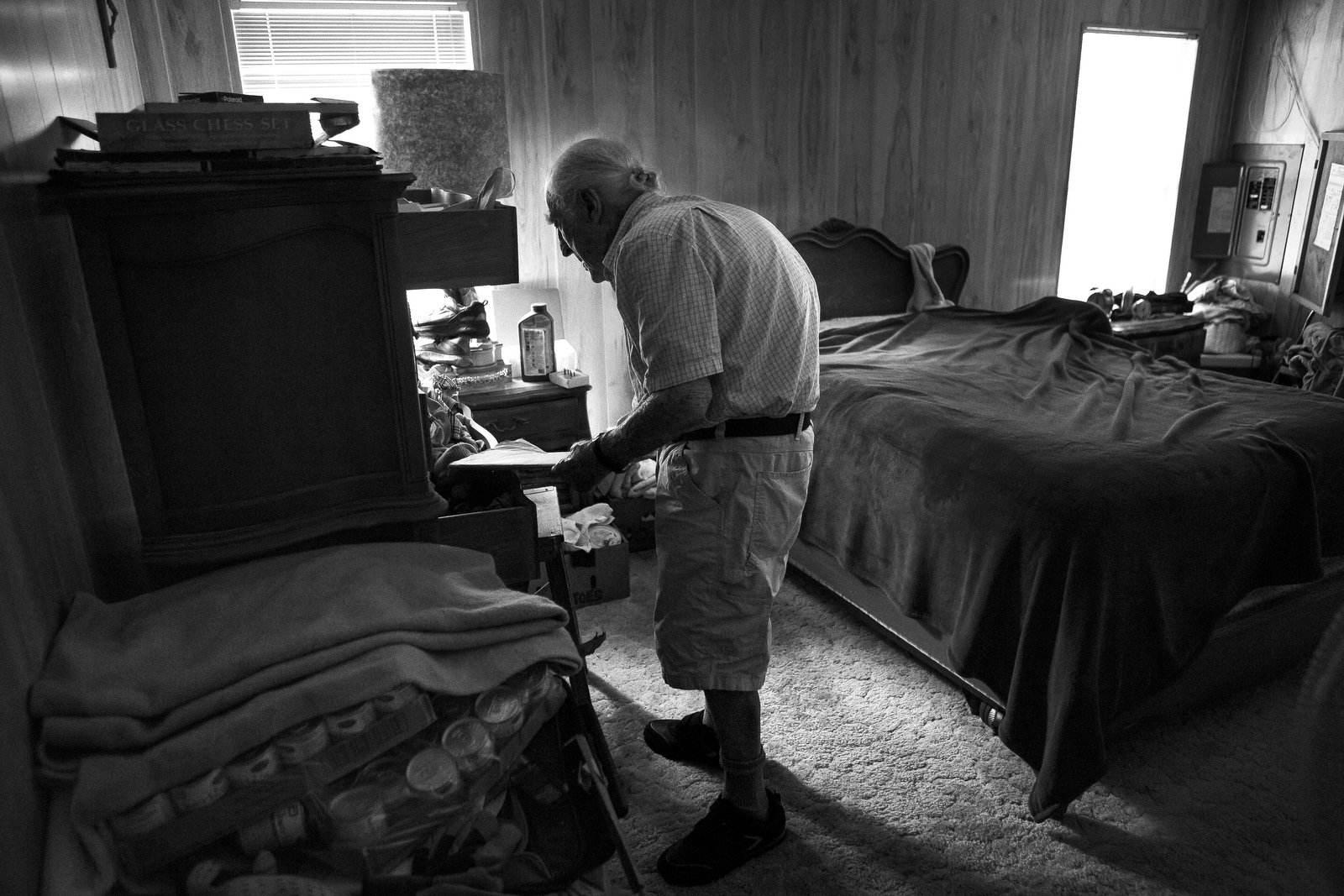  Charles Asaro, 98, stands in the bedroom of his home. He has lost much of his eyesight and although he fell into a hole in the floor of his bathroom, he would prefer to continue to live independently. 