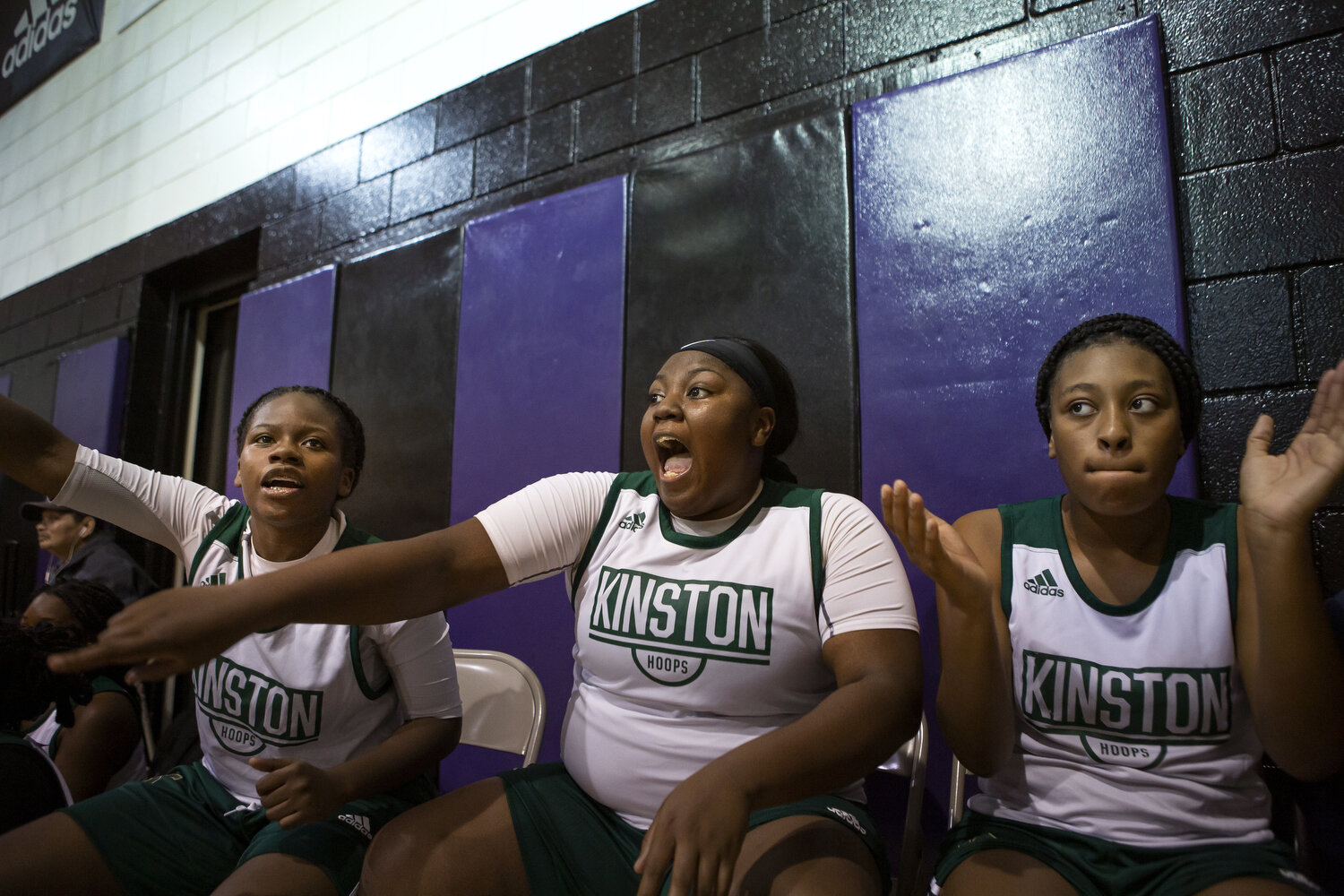  (Left to right) Sheriece Jones, Zykia Andrews, and Quiaira Powell cheer for their teammates during a jamboree hosted by Kinston.  