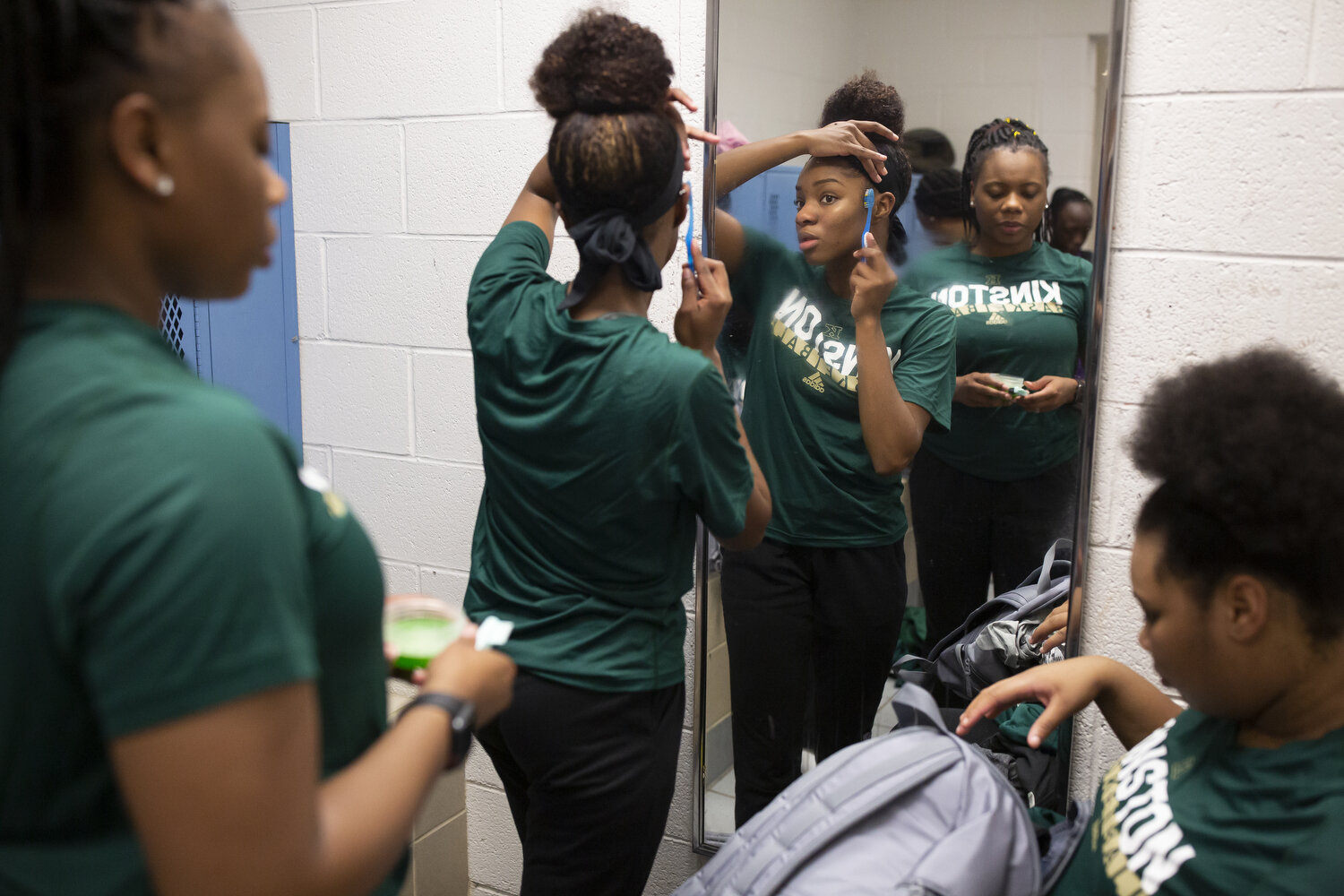  Senior Lesley Sutton, center, fixes her hair along with teammates Taliyah Jones, left, and Anzaryia Cobb, right, following a game.  