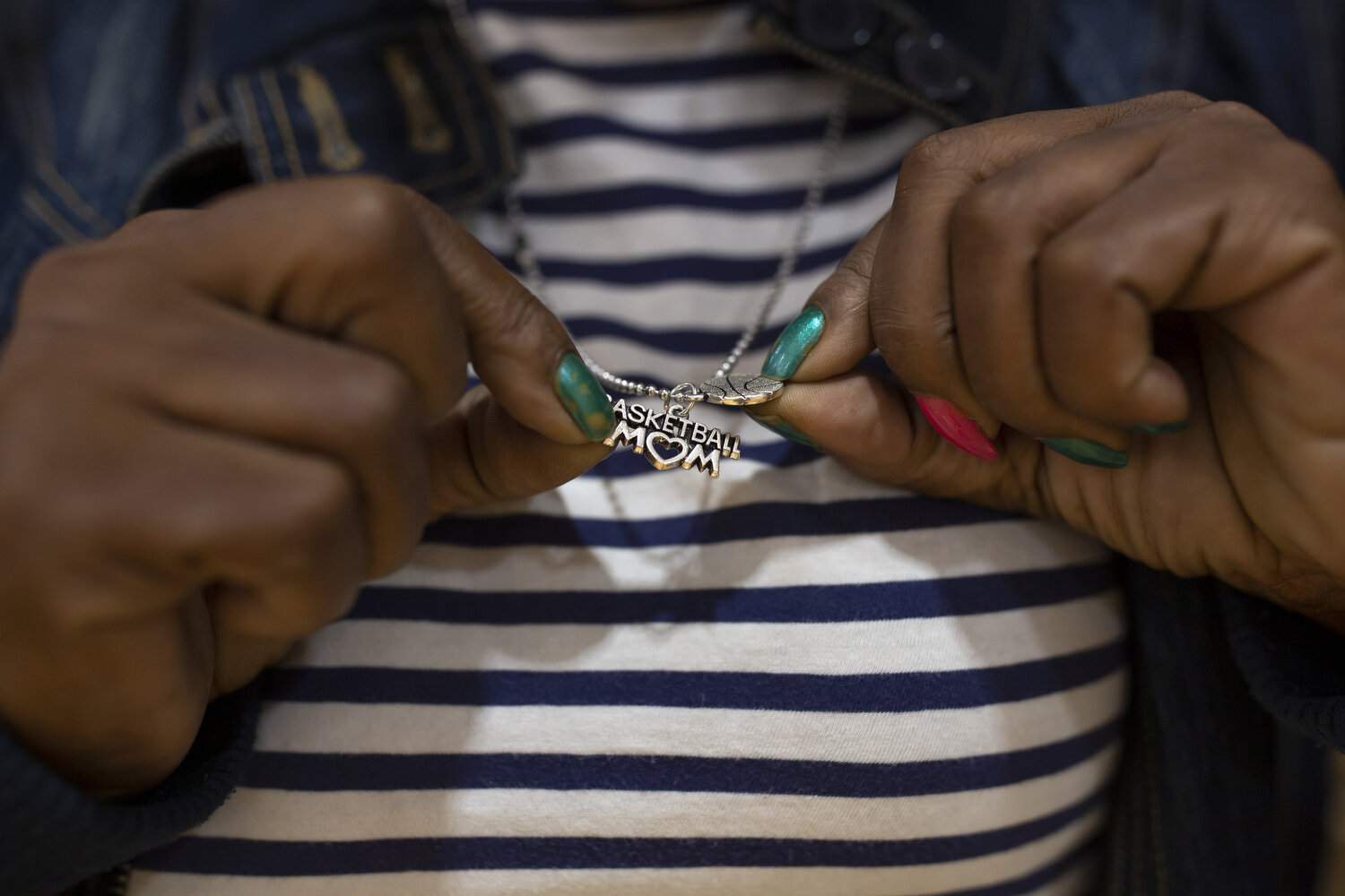  Michyla Dove's mom Lori Carmon holds her "basketball mom" necklace. Carmon travels to all of Dove's games and says she plans to do the same when Dove plays for Barton College about an hour away next year.  