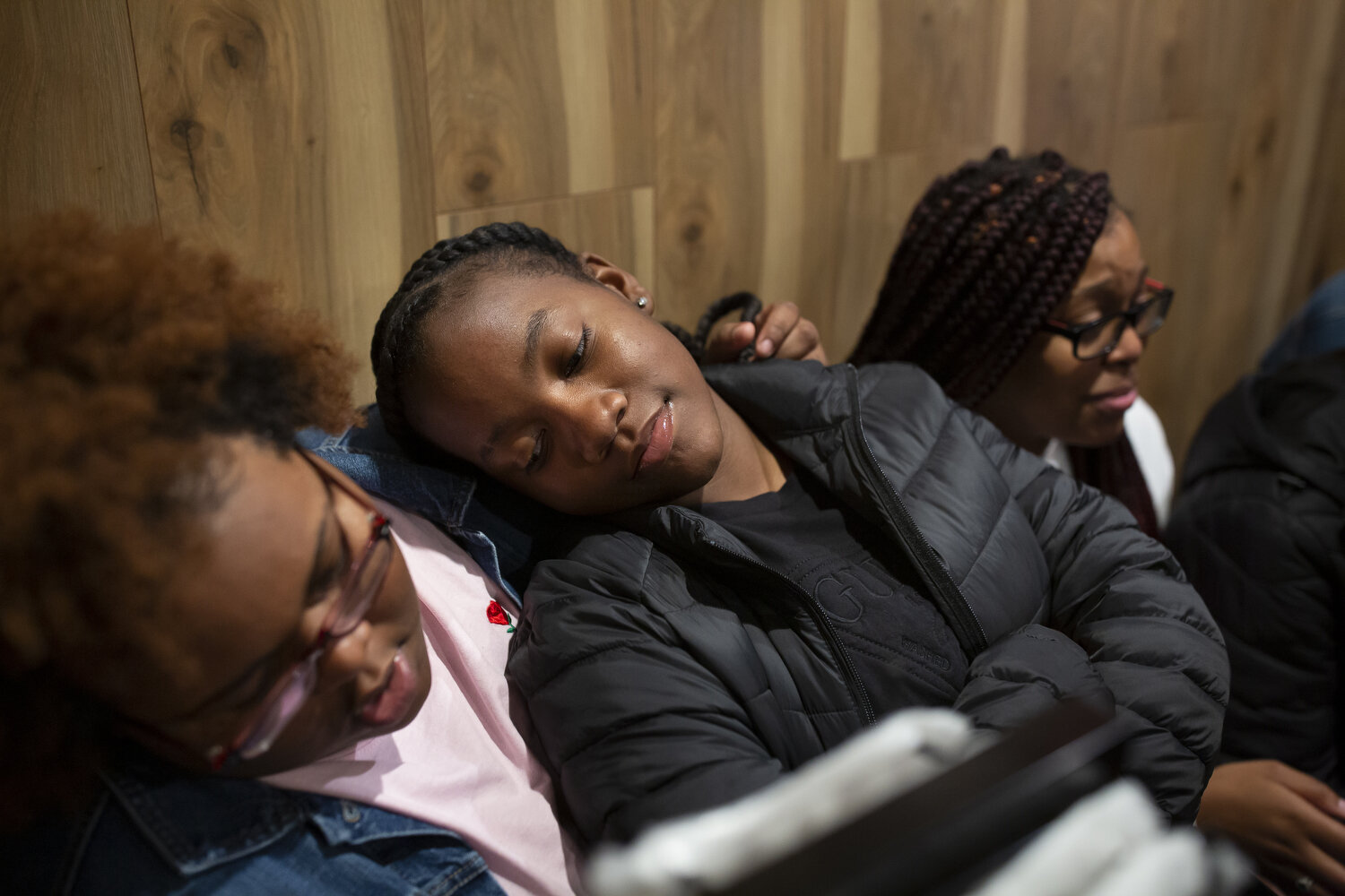  Michyla Dove rests her head on a friend's shoulder while waiting to celebrate her teammate Zykia Andrews's eighteenth birthday. 