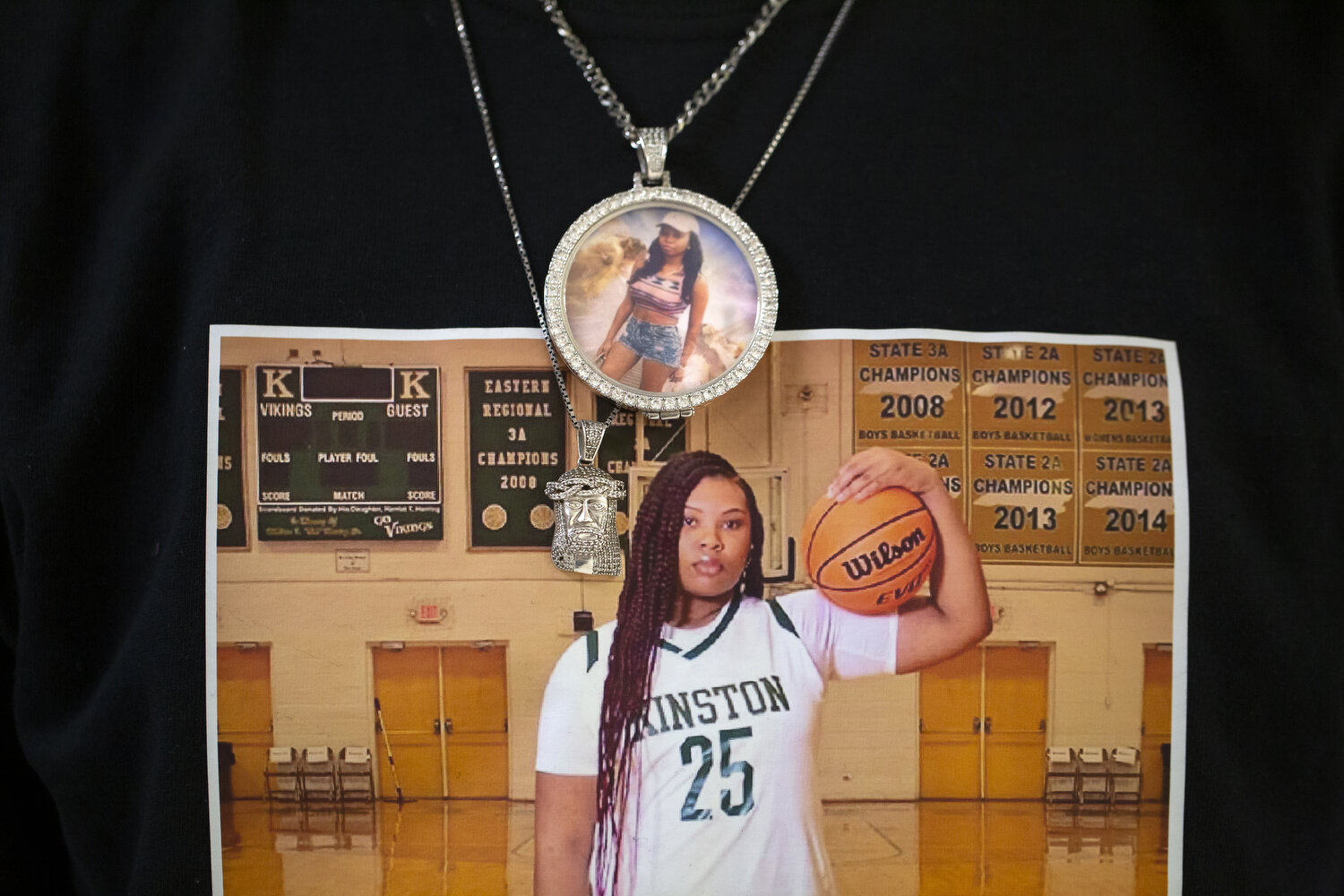  Senior Anzaryia Cobb's brother Ervin Jones wears a shirt with a photo of his sister during senior night celebrations. 