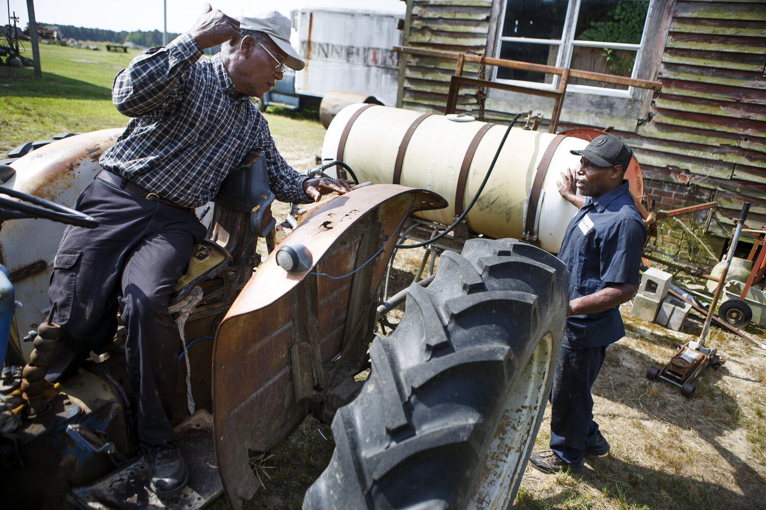  James Shackleford, 74, of Snow Hill, works on his farm with his neighbor Mike Phillips as they try to repair one of the tractors. Shackleford explains that he has faced the racist practices of USDA employees and lenders as he has been able to piece 