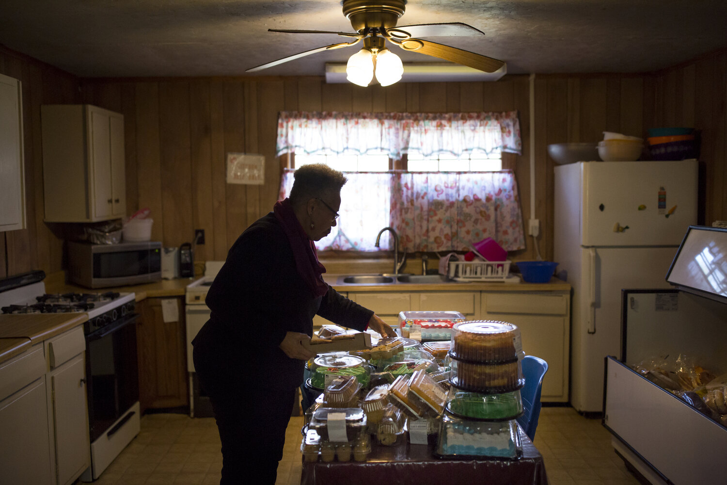  Doris Davis organizes donated food at the community center in Tillery. She and Gary Grant are descendants of the original families who relocated to Tillery as part of a government resettlement program for former Black sharecroppers. Most of the desc