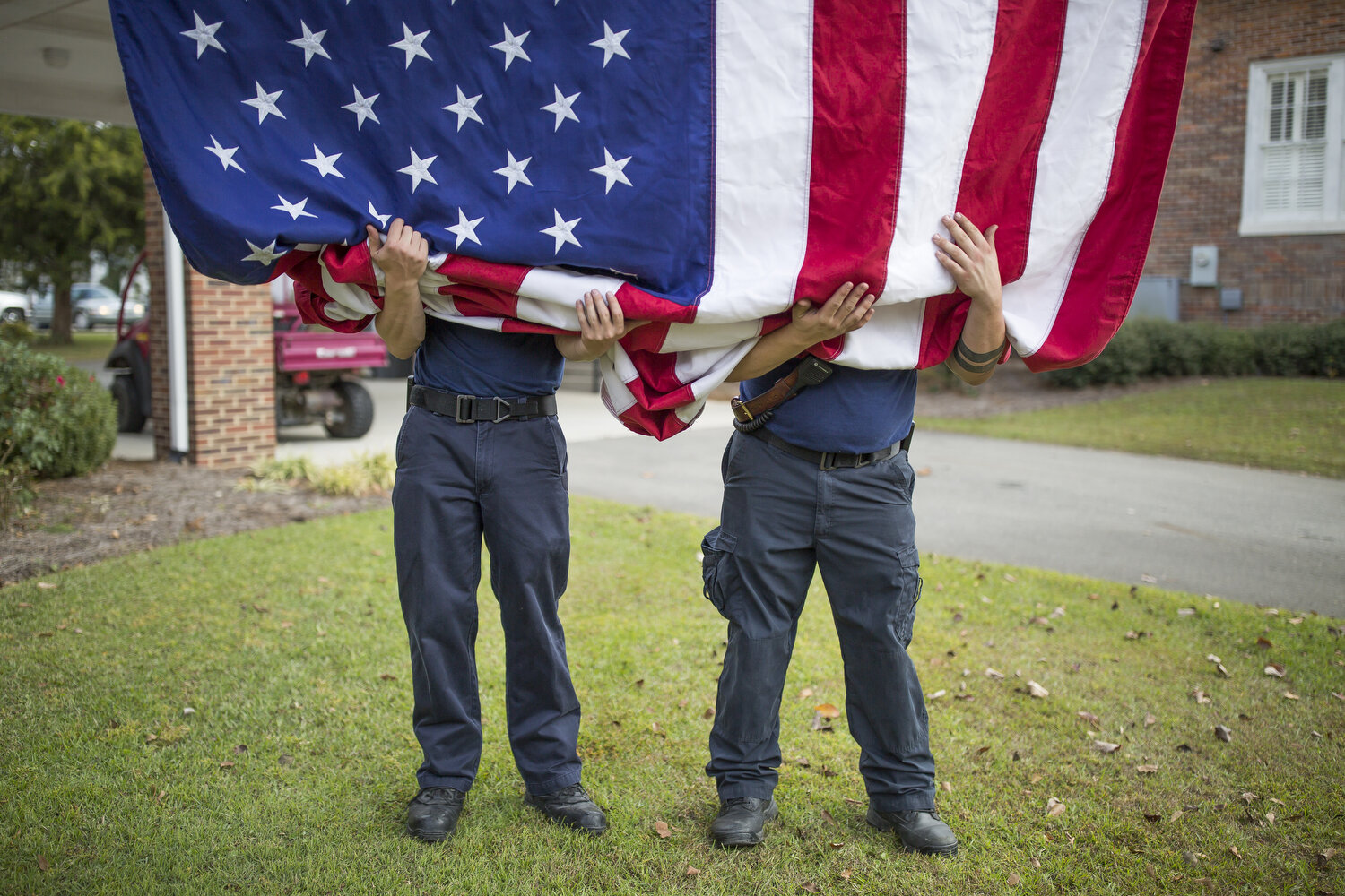  Firefighters Jarrett Blackmore and Dillon Southerland keep the American flag from touching the ground. 