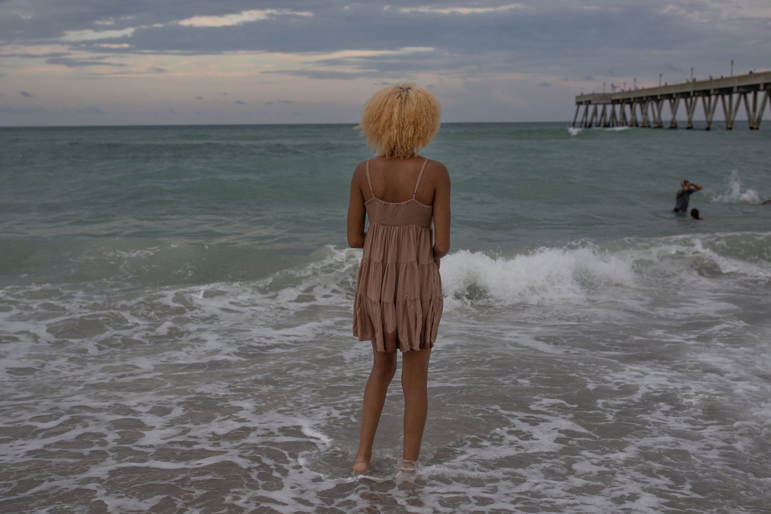 Tyanna Grissett stands in the surf as the sun goes down at Wrightsville Beach, North Carolina. With heat indexes soaring into the 100s in North Carolina, many beachgoers are opting to visit in the evening when it’s cooler.  For The Washington Post 