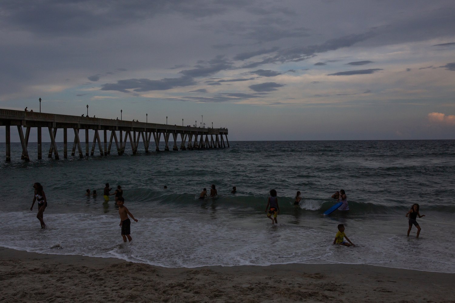  People play in the waves as the sun goes down at Wrightsville Beach, North Carolina.   For The Washington Post 