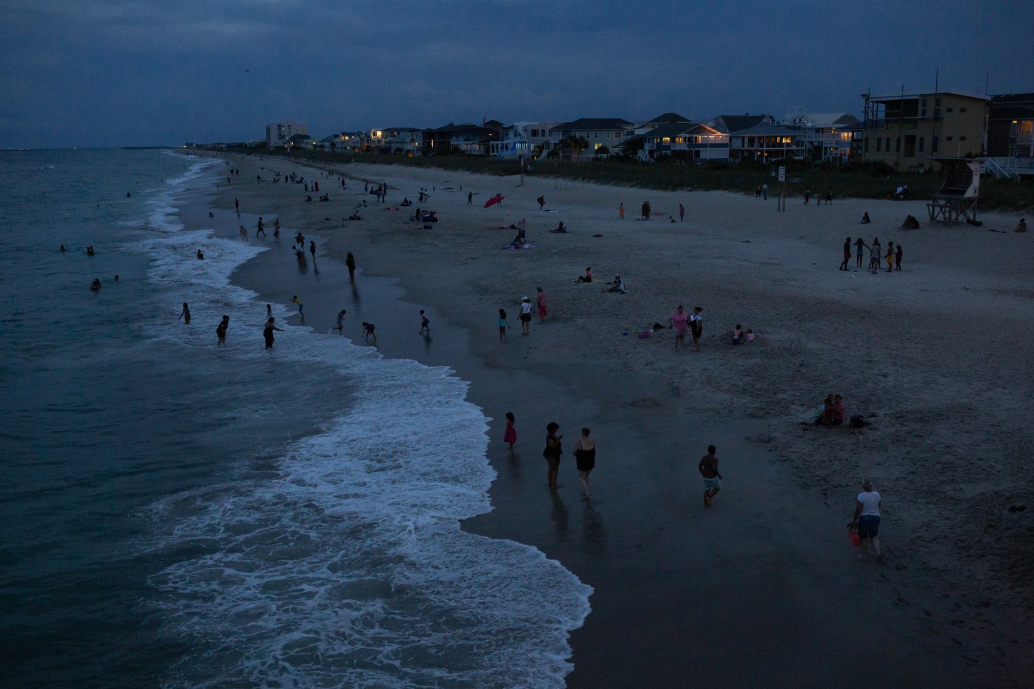  People dot the beach at Wrightsville Beach, North Carolina. With heat indexes soaring into the 100s in North Carolina, many beachgoers are opting to visit once the sun has gone down.  For The Washington Post 