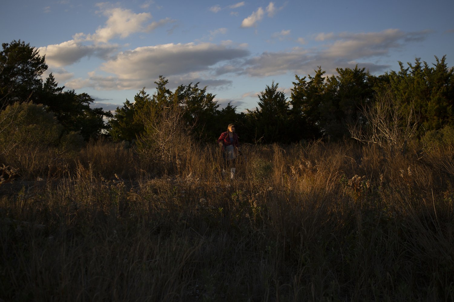  Ana Shellem, who owns Shell’em Seafood, walks across an island near Wrightsville Beach, North Carolina after harvesting prickly pears.  For The New York Times 