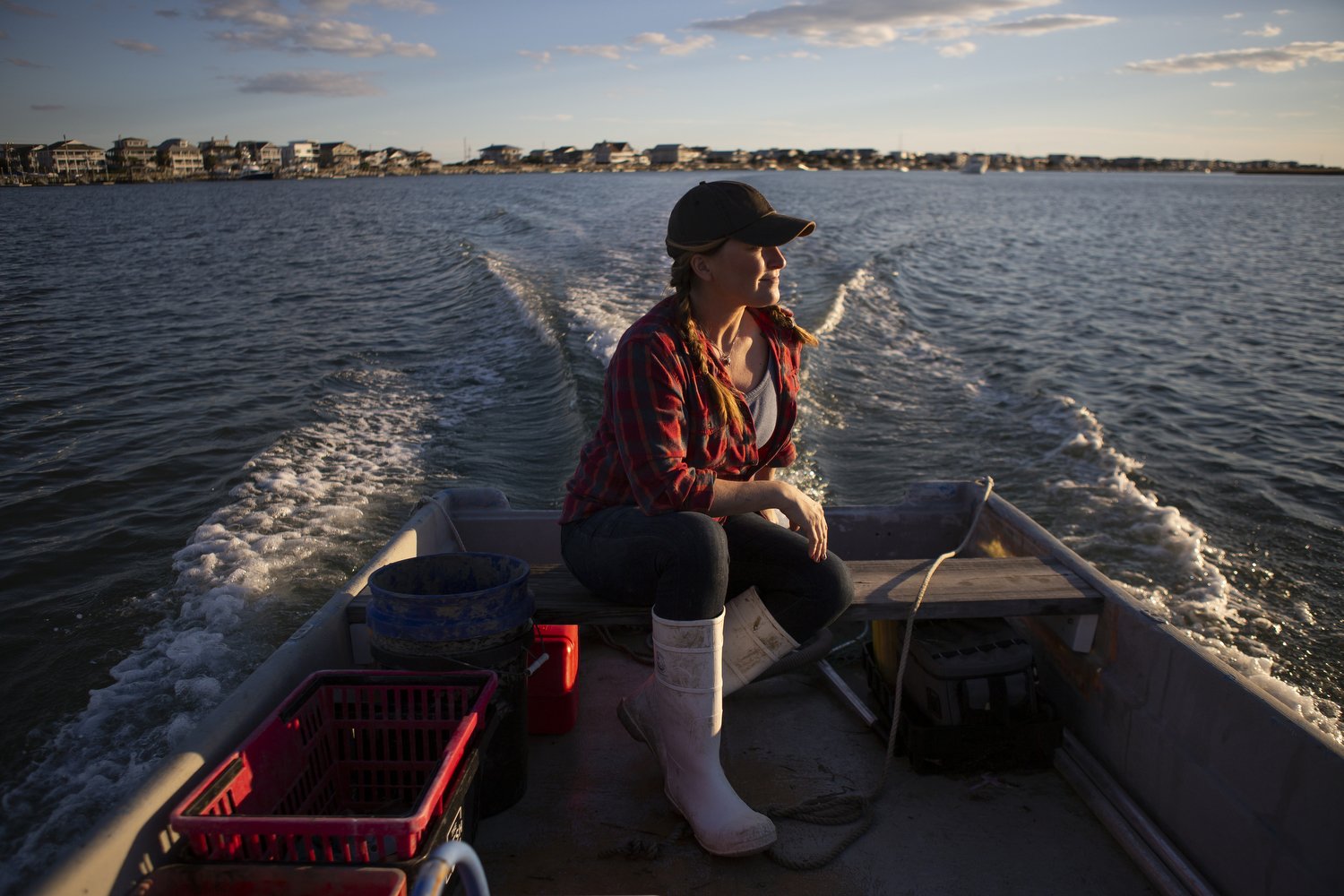  Ana Shellem, who owns Shell’em Seafood, navigates her boat through the waters near Wrightsville Beach, North Carolina.  For The New York Times 