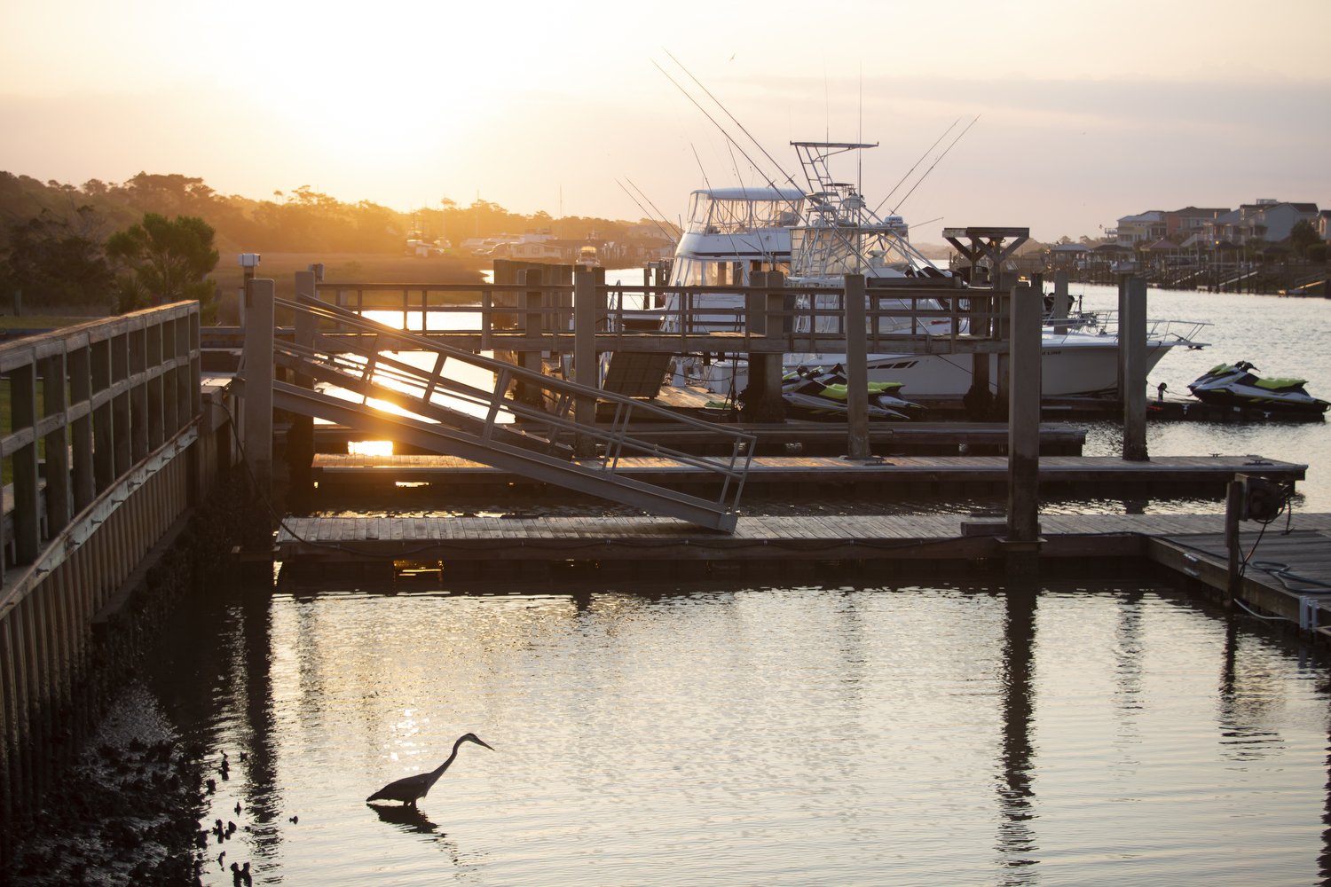  The sun rises over the Holden Beach Marina where Cane Faircloth docks his Ollie Raja charter boats in Supply, North Carolina. Faircloth’s family has lived in the area for generations and their lives and livelihoods are closely tied to the ocean. Wit