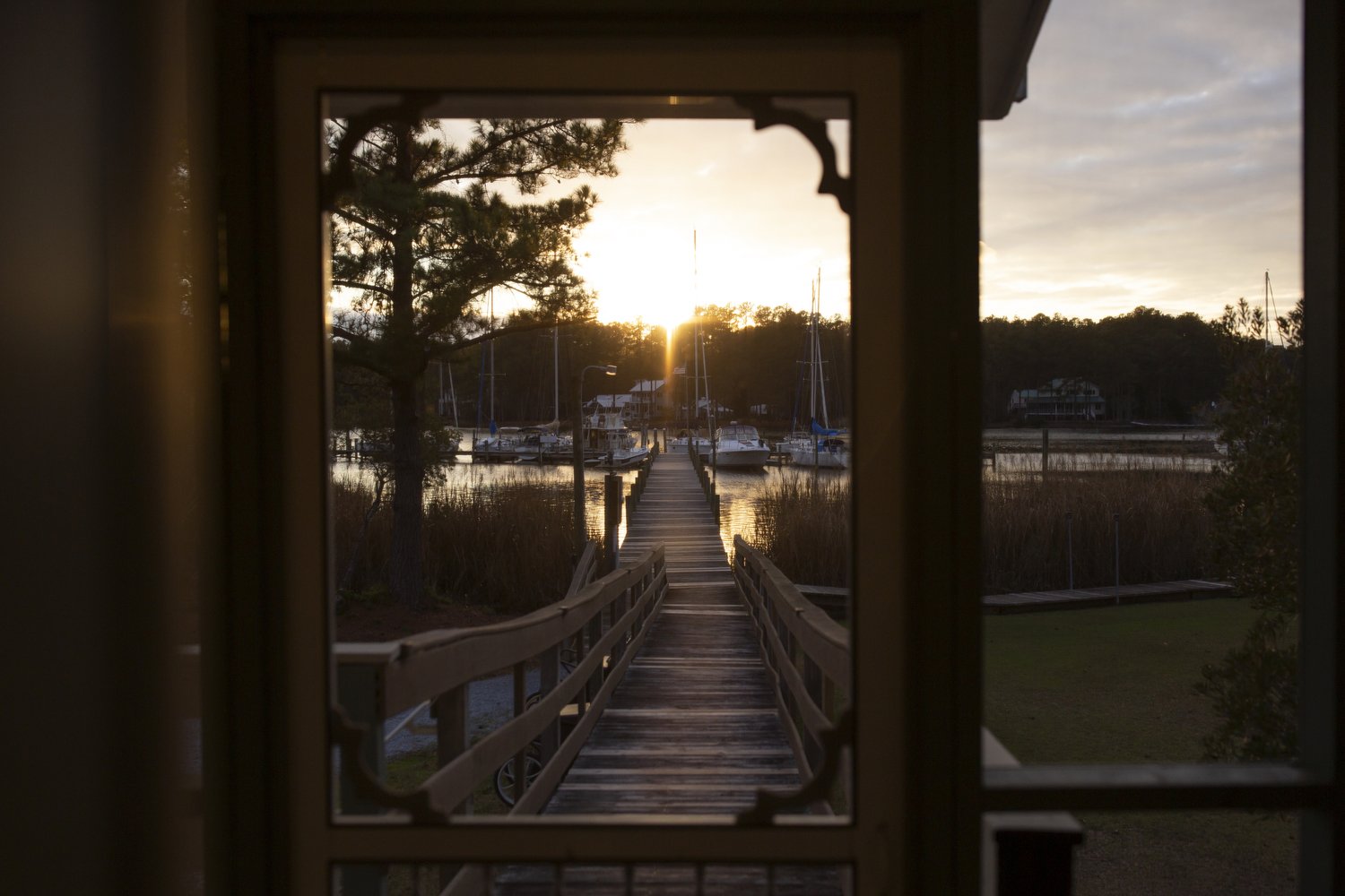  The sun sets over the Ensign Harbor Marina in Merritt, North Carolina. Dan Parsons and Perry Cooper dock the sailboat that they lived on for six months during the pandemic at the marina.  For The Washington Post 