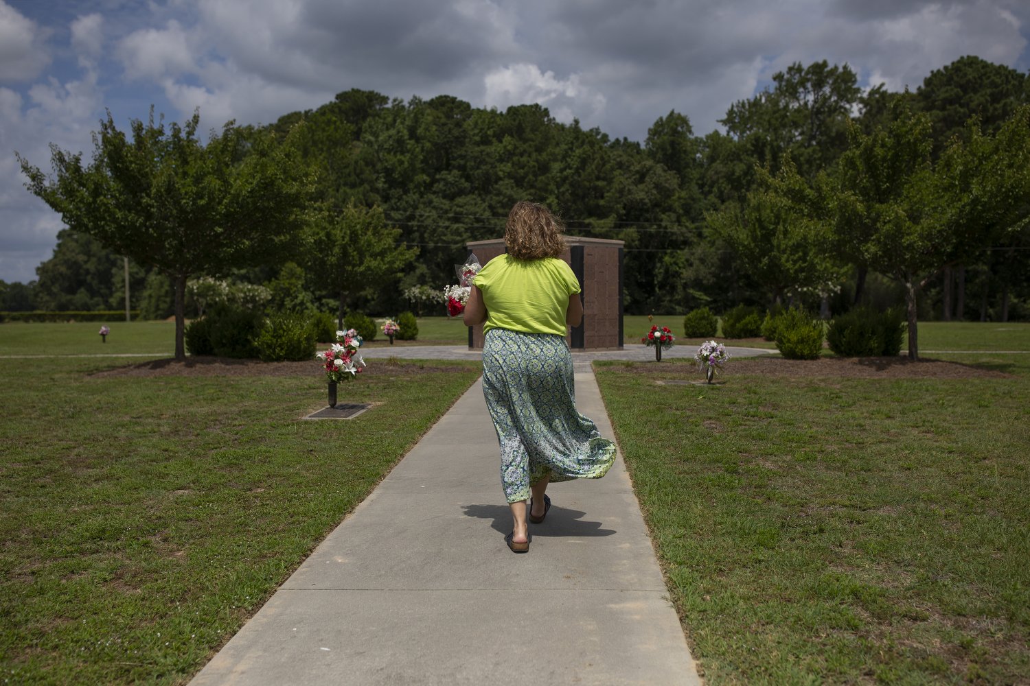  Fran Lunsford Laughinghouse walks up to the columbarium that holds both of her sons’ ashes at the Pinewood Memorial Park in Greenville, North Carolina. Jackson and Alex Laughinghouse both died of opioid overdose. Fran felt that it was important to h