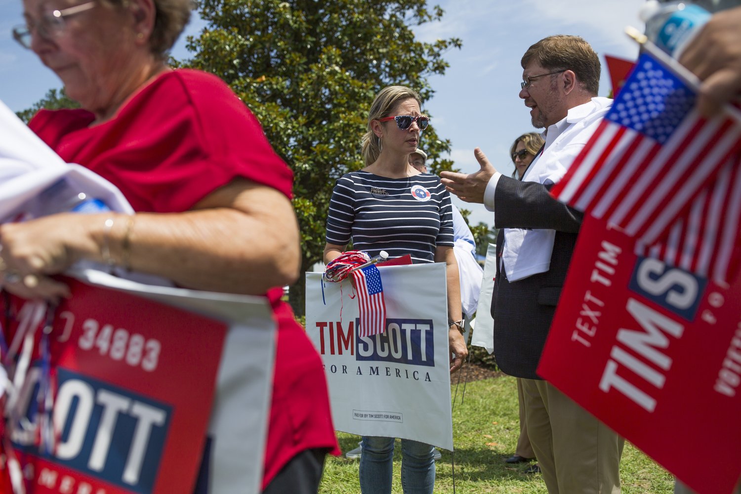  Angelina Davenport, left, a member of the Berkeley County chapter of Moms for Liberty, talks with Berkeley County School Board member Michael Ramsey, right, after an event for presidential candidate Tim Scott at Charleston Southern University.  For 