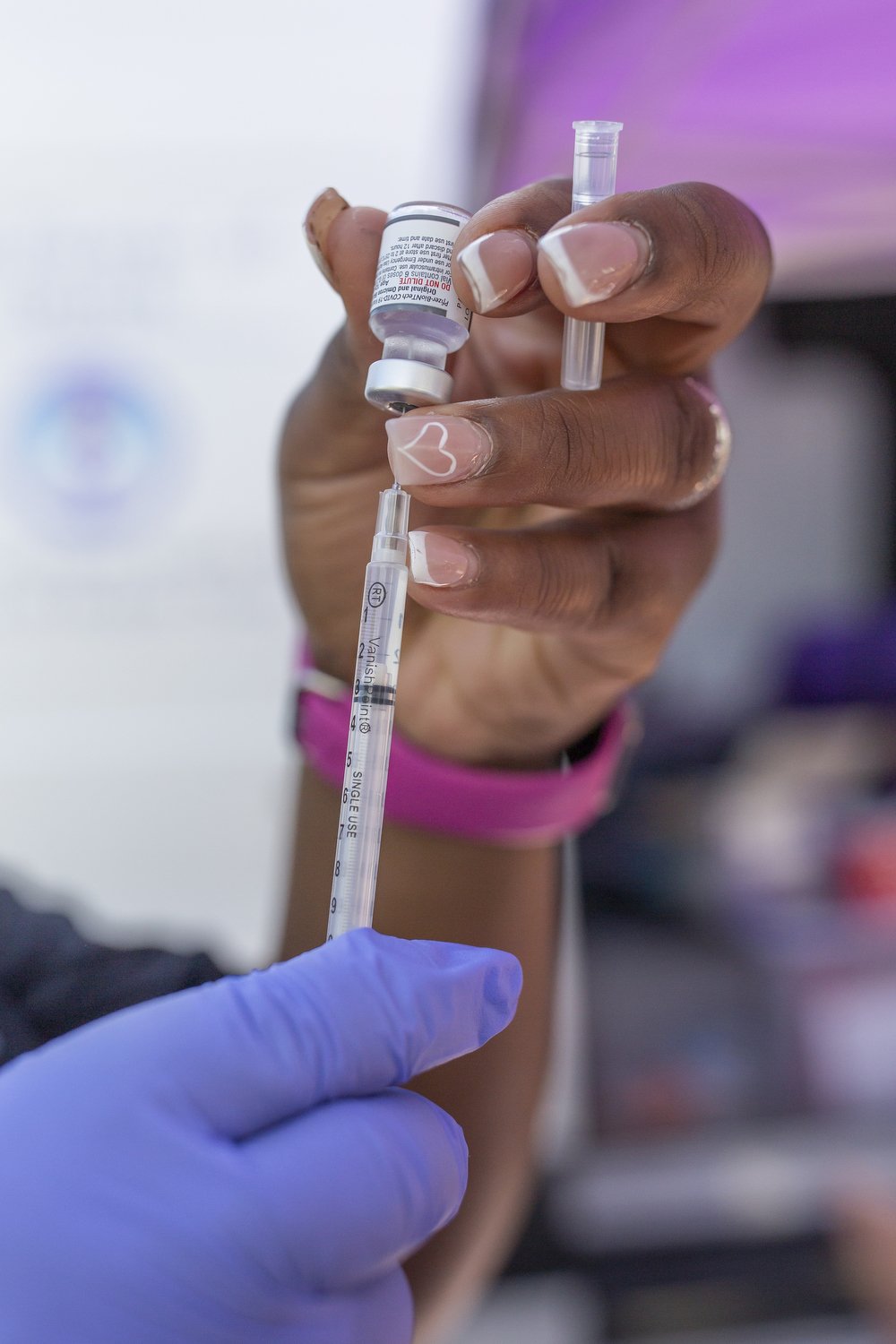  Mikara Smith-Hendricks prepares Covid vaccines during an outdoor clinic hosted by her mother Dr. Karen Smith in Raeford, North Carolina. Dr. Smith has served the rural community for decades building trust with her patients and continues to hold conv