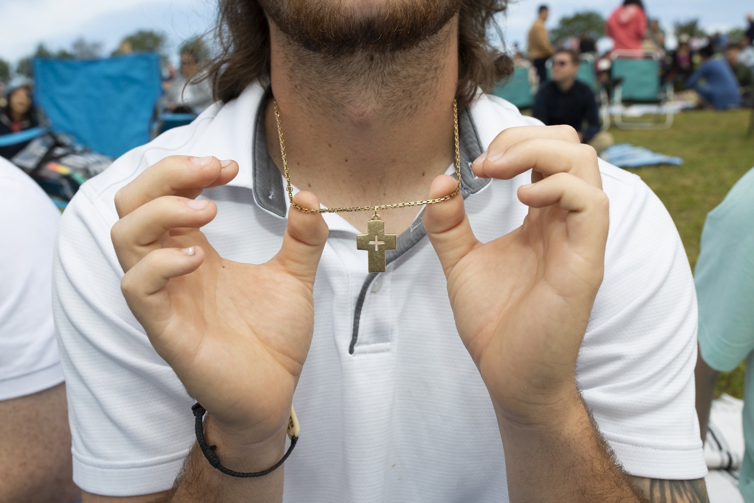  Justin Walsh holds up his cross necklace while waiting for the Summit Church Easter Sunday service to begin at Walnut Creek Amphitheater in Raleigh. Pastor J.D. Greear, who leads the church, preached about eternal life after death and encouraged att