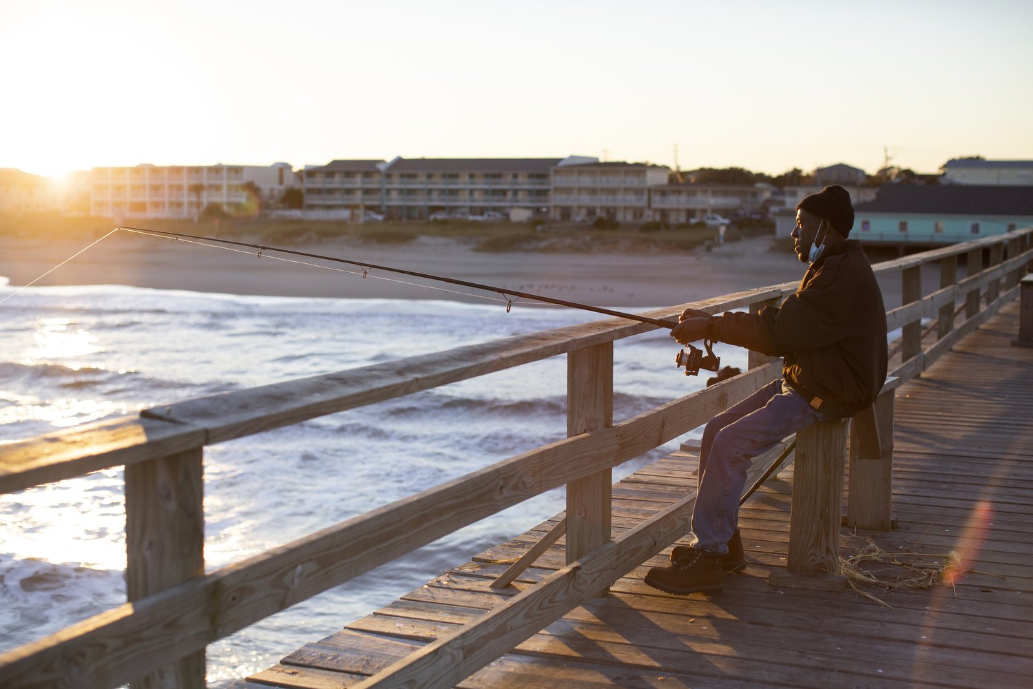  Curtis Thompson fishes on the opposite side of the pier as everyone else in Kure Beach, North Carolina.  For The Washington Post 