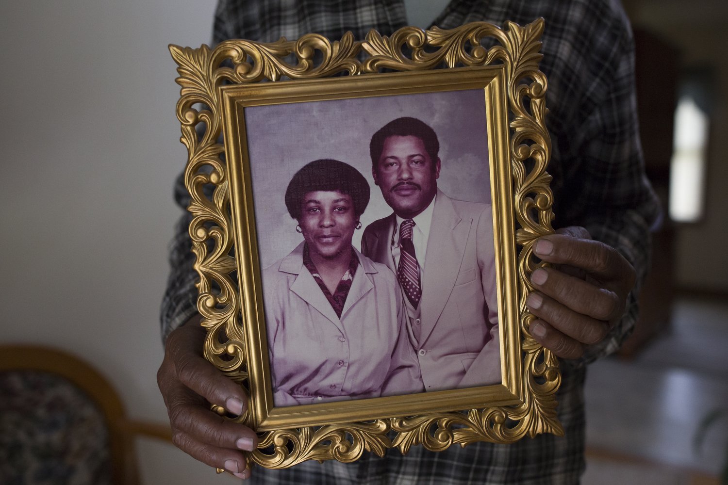  Levi Grissett holds a photo of his wife Frances McMillan Grissett, and himself at his home on his family land in Supply, North Carolina. Grissett, who has become know for his unique heirloom collard greens, only started growing collards because his 