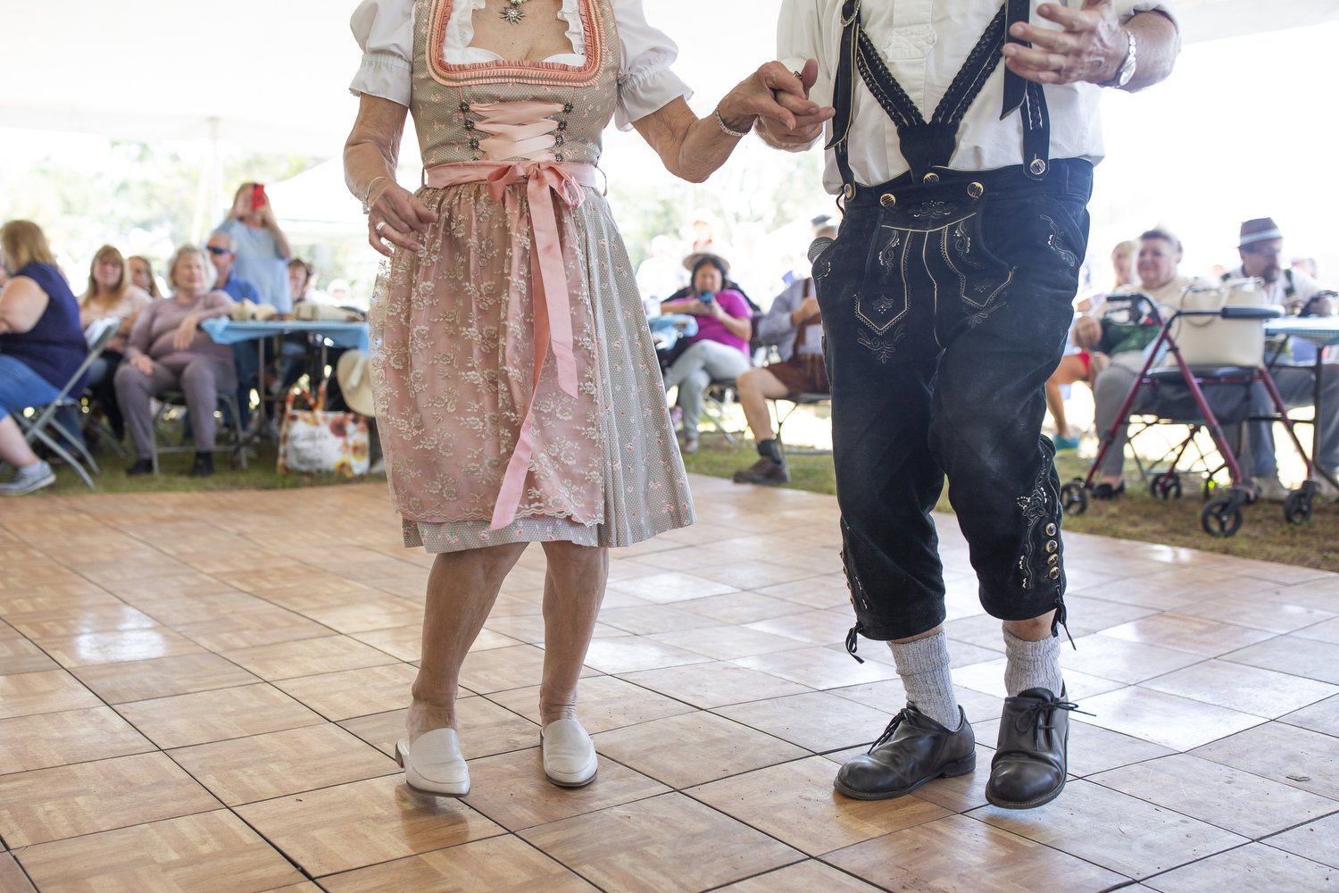  Hanna Philipp, left, and Ken Macior, right, dance together at the ninth annual Oktoberfest celebration in Calabash, North Carolina. The festival featured the Harbour Towne Fest Band, which Macior founded nearly 30 years ago, as well as a bierstein h