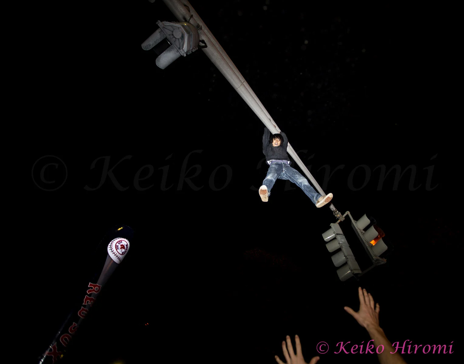 October 30 2013, Boston, MA USA; A Fan takes turn to jump off of traffic light during the celebrate the Red Sox victory over the St Louis Cardinals to win the World Series just outside the Fenway park in Boston, MA. 