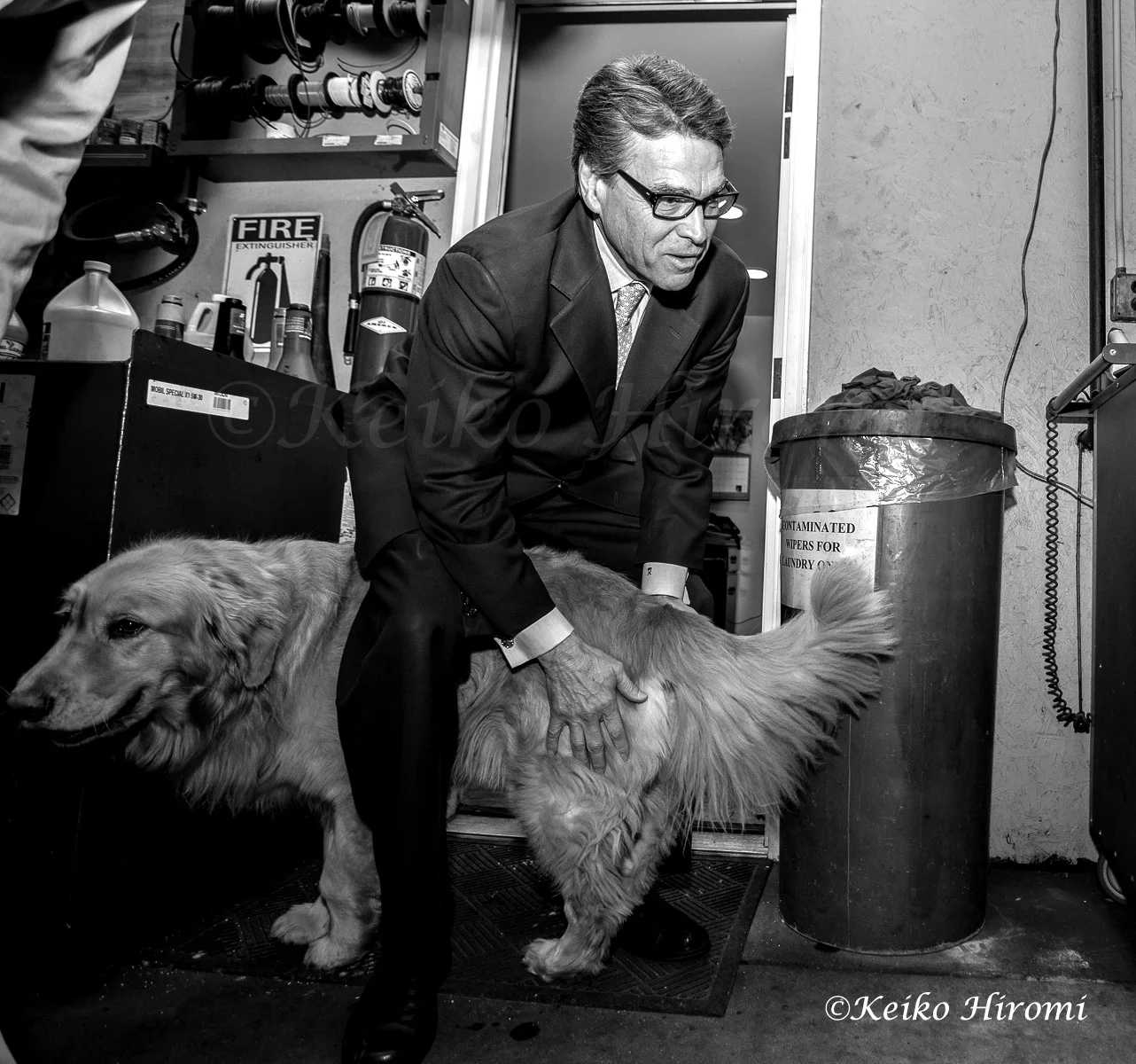 Former Texas Gov. Rick Perry plays with Chester, Golden retriever at Weed Automotive in Concord, N.H on March 12, 2015.