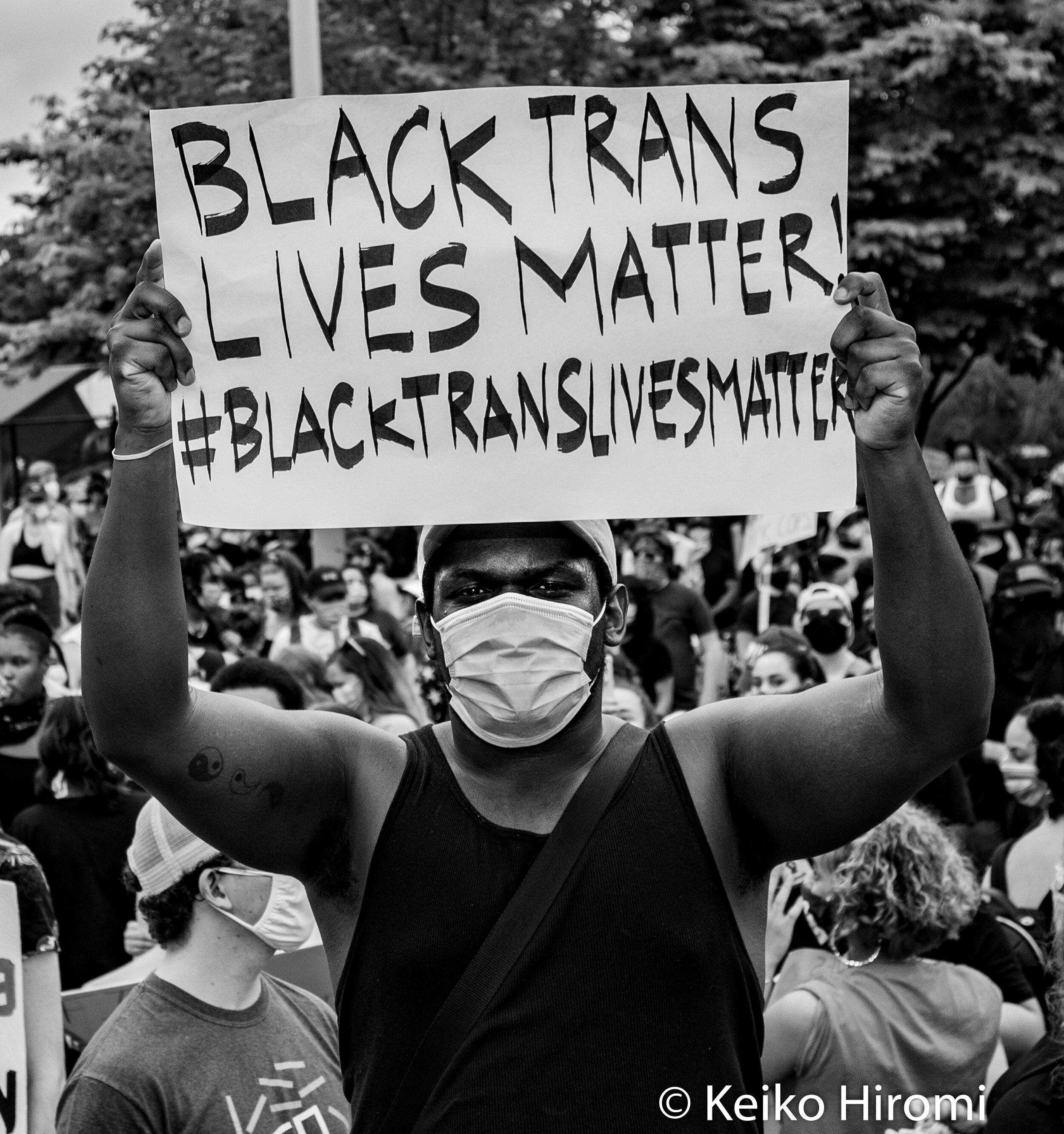  May 29, 2020, Boston, Massachusetts, USA: A protester holds a sign "Black Trans Lives Matter" during a rally in response to deaths of George Floyd and against police brutality and racism at Peter's park in Boston, Massachusetts. 