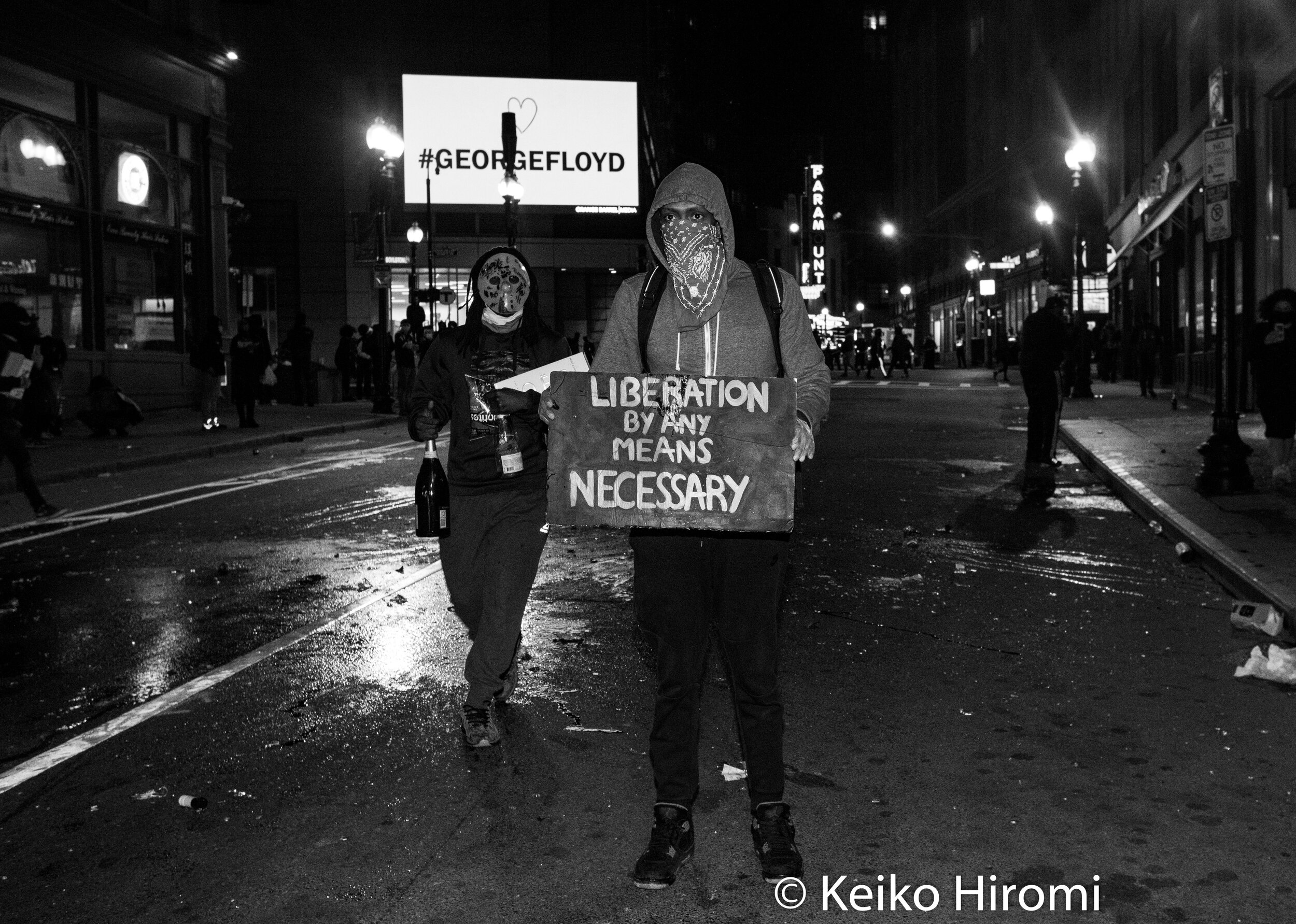  May 31, 2020, Boston, Massachusetts, USA: A protester atood with his sign "Liberation by any means necessary"  after rally in response to deaths of George Floyd and against police brutality and racism, on Washington Street in Boston. 