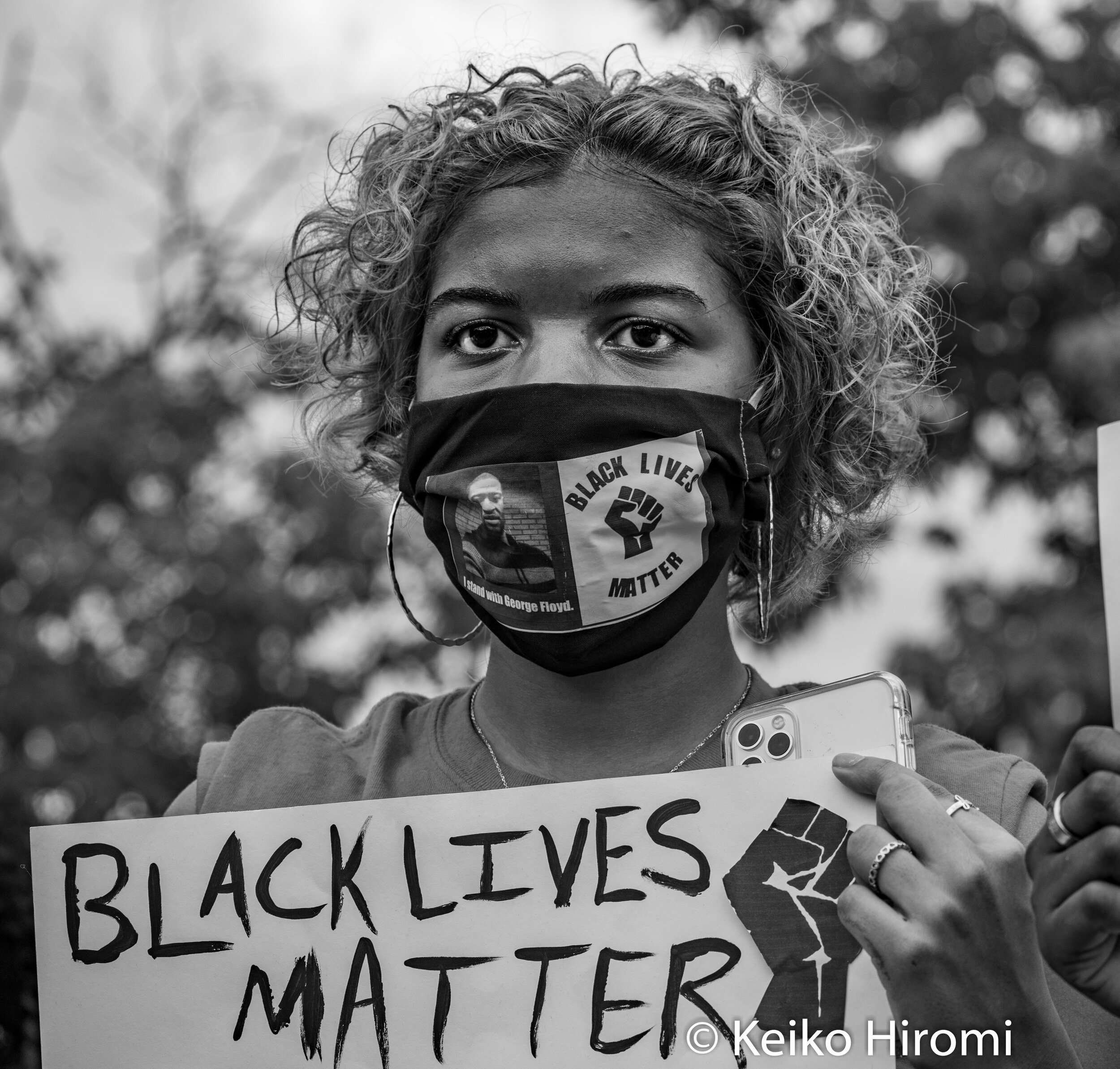  May 29, 2020, Boston, Massachusetts, USA: A protester holds a sign "Black Lives Matter" during a rally in response to deaths of George Floyd and against police brutality and racism at Peter's park in Boston, Massachusetts. 