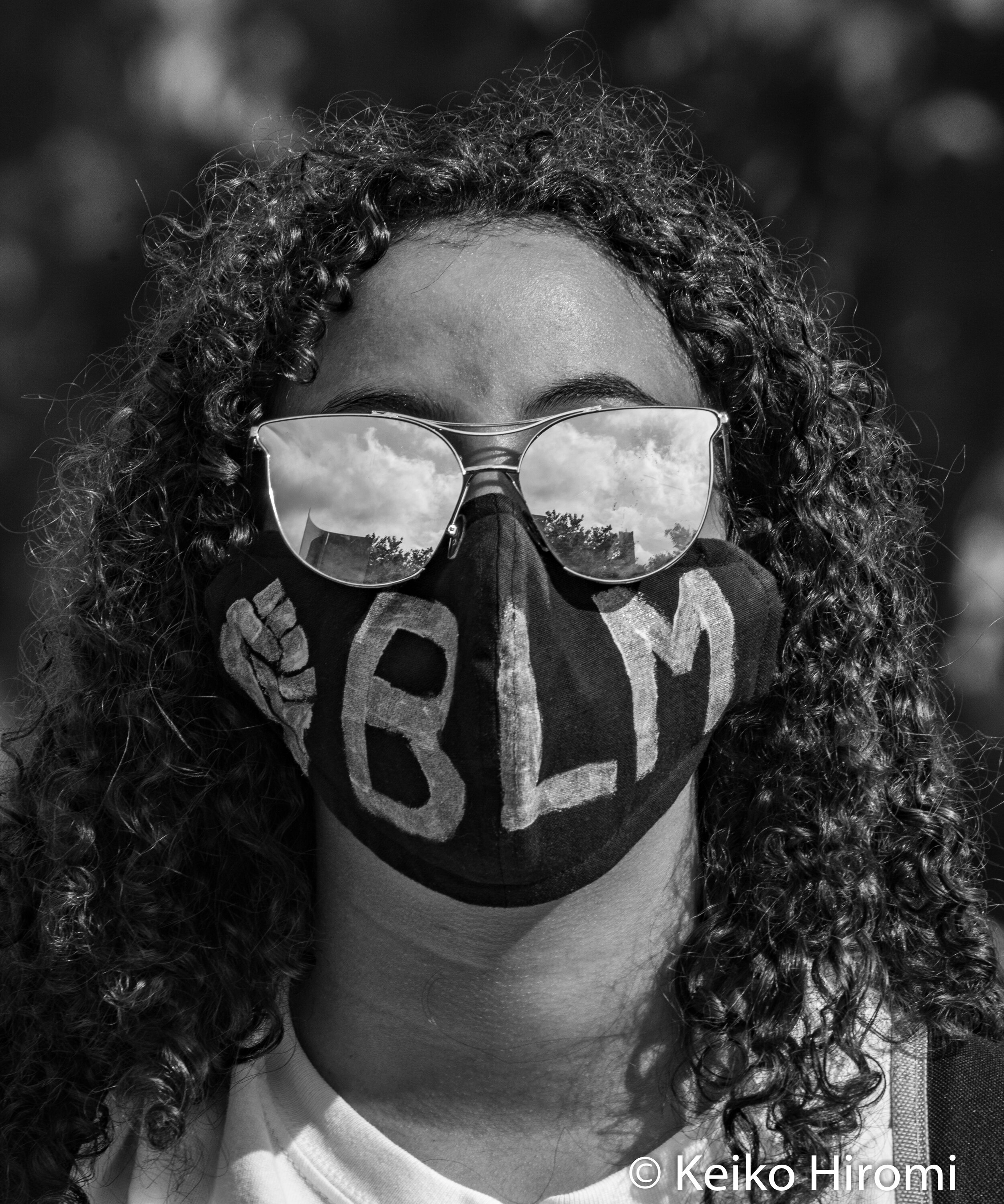  May 29, 2020, Boston, Massachusetts, USA: A protester wears a face mask "BLM" during a rally in response to deaths of George Floyd and against police brutality and racism at Peter's park in Boston, Massachusetts. 